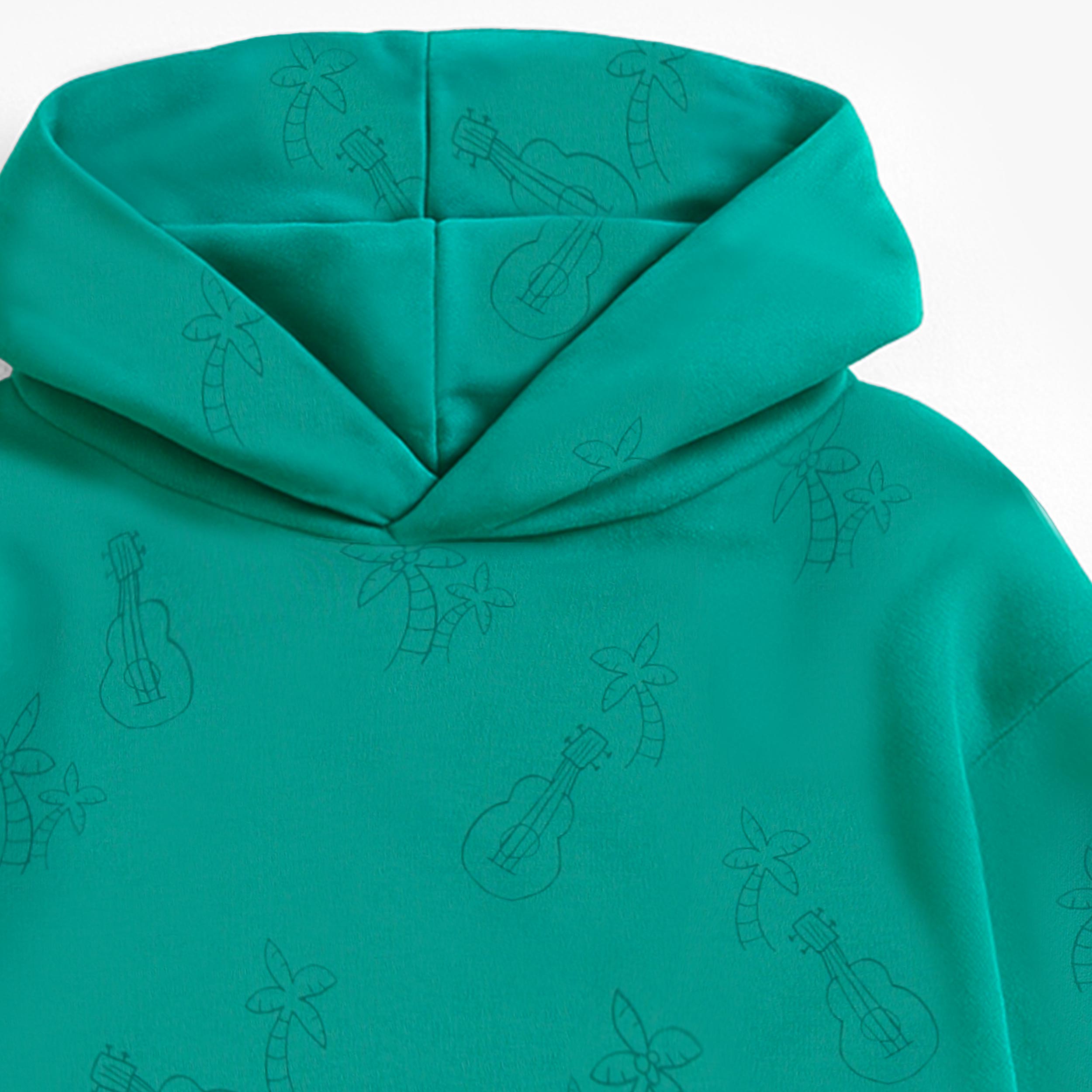 Zoom détails capuchon du chandail à capuchon turquoise à motifs de palmiers et guitares, enfant