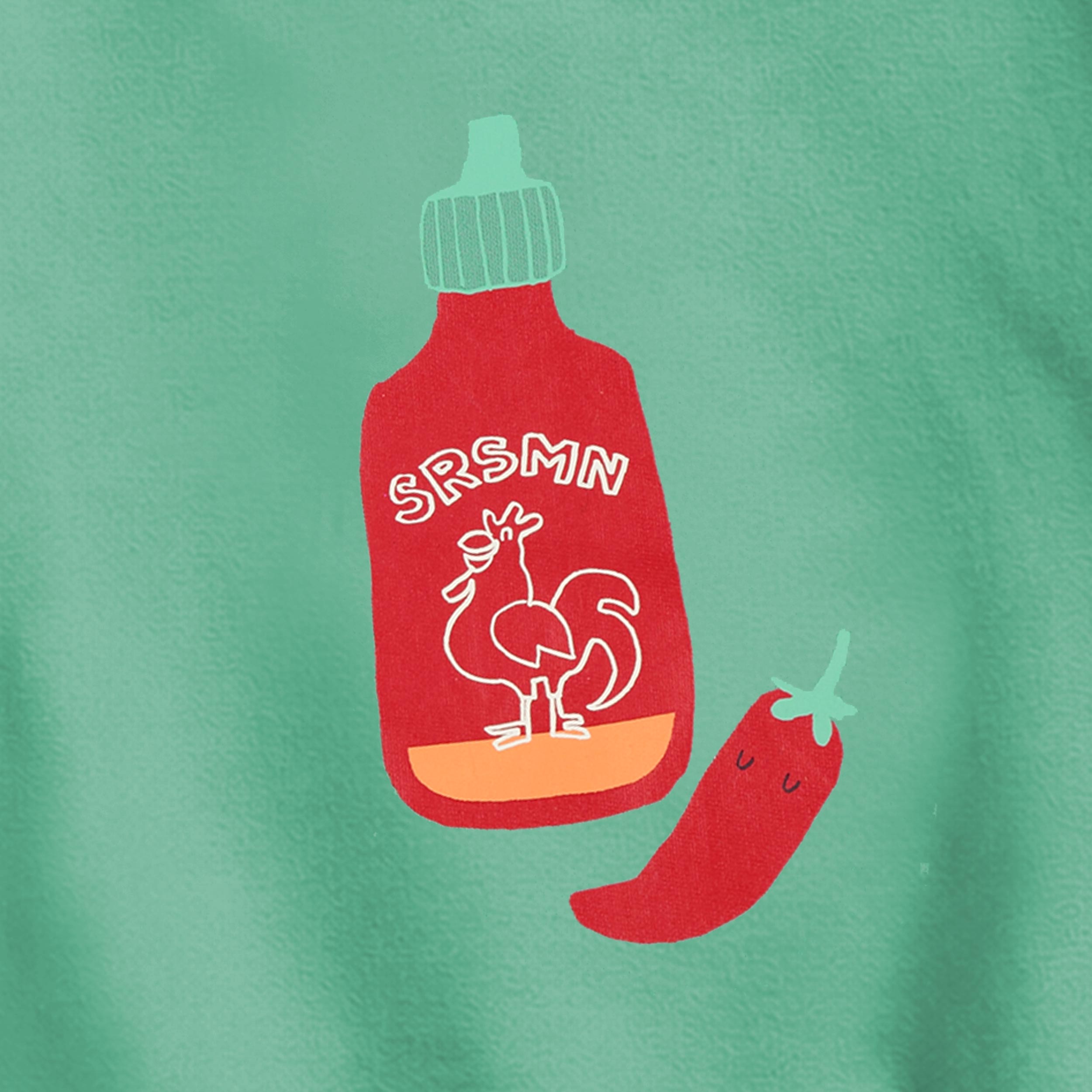 Zoom détails du chandail vert avec illustration, enfant