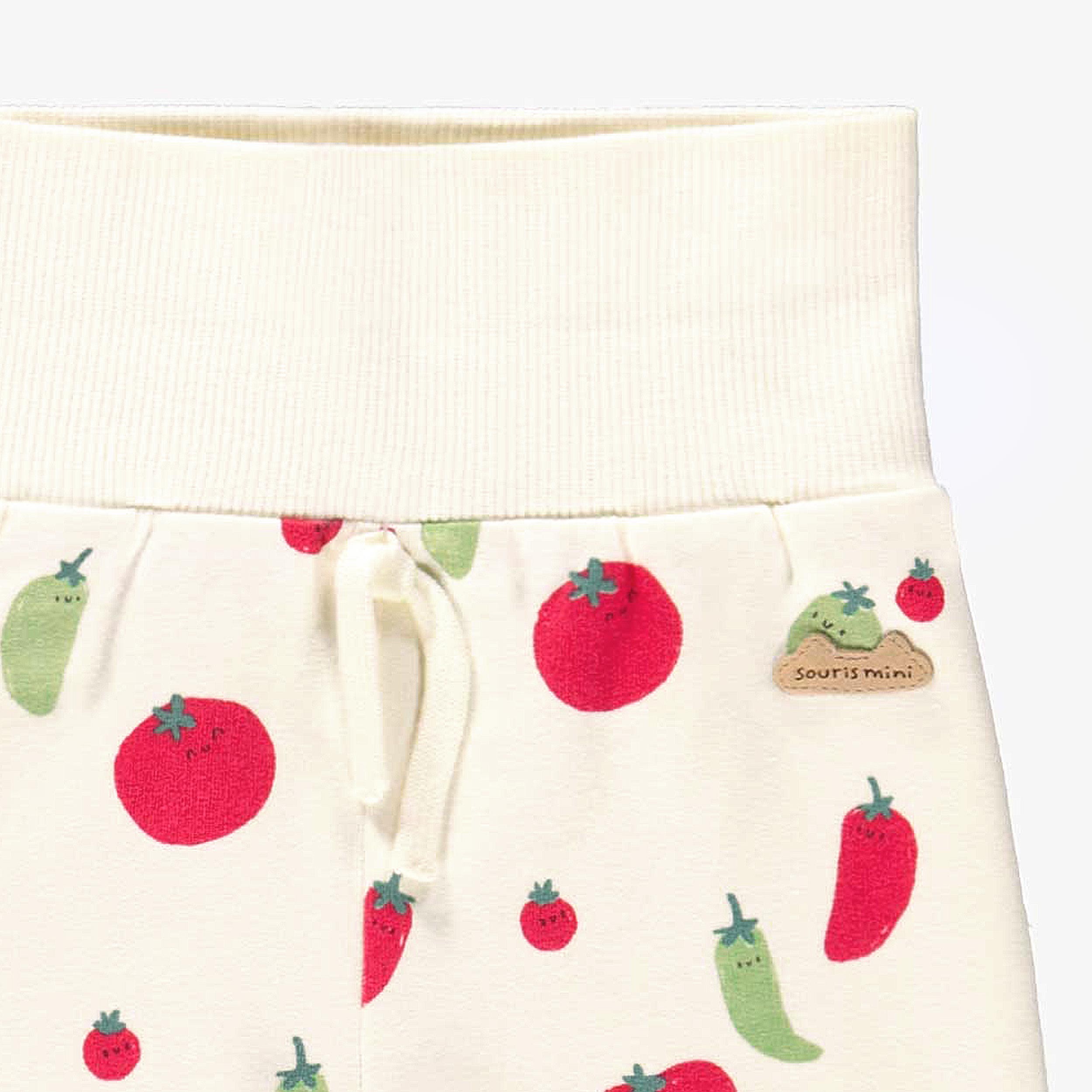 Zoom détails de l'évolution du pantalon crème à motifs de tomates et piments, naissance