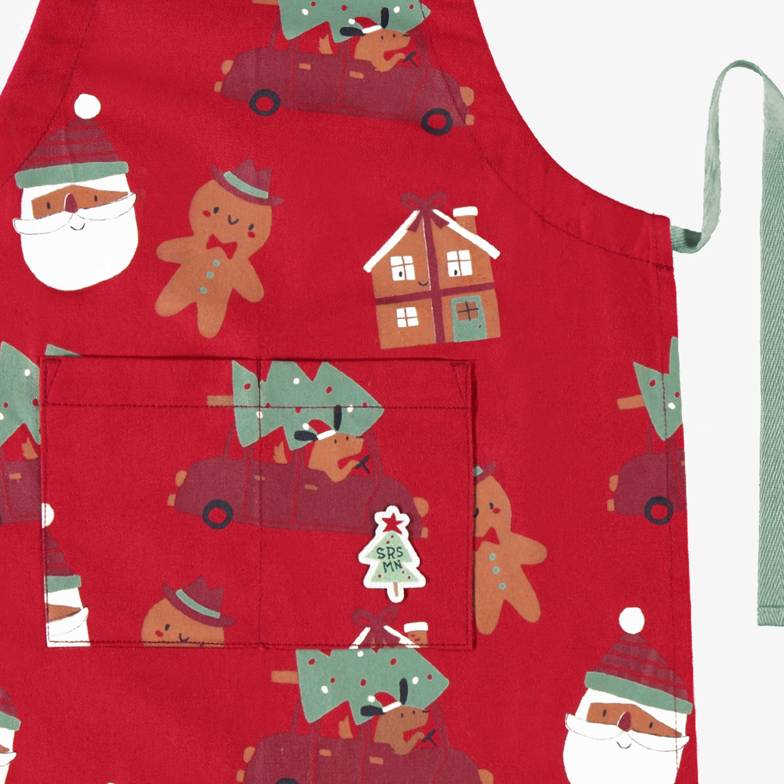 Zoom détails du tablier rouge à motifs des Fêtes, enfant