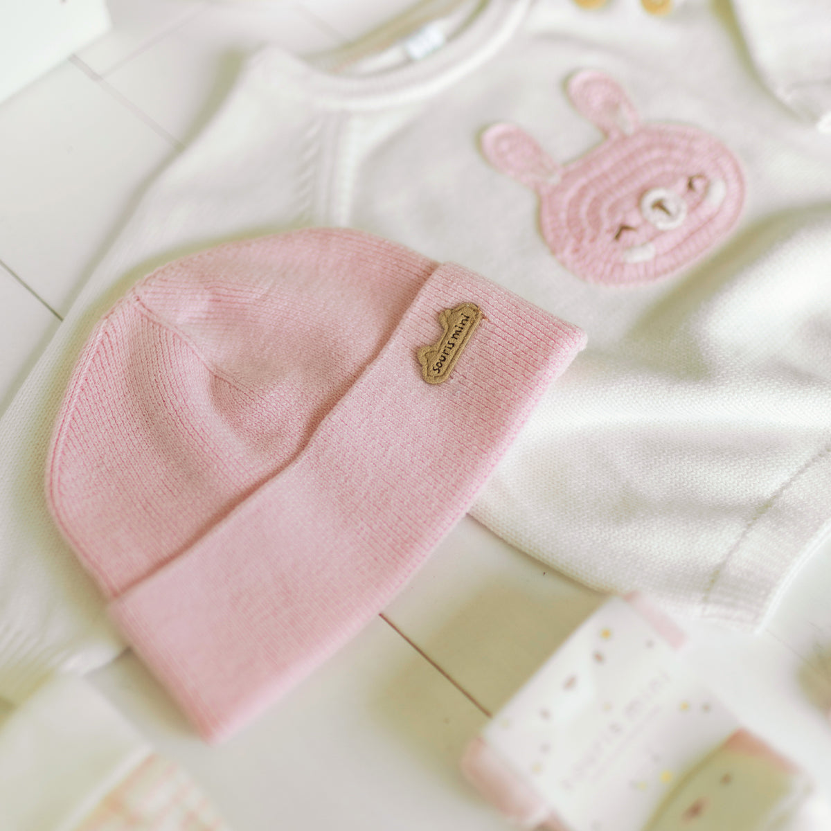 Bonnet rose et chandail crème en maille pour naissance