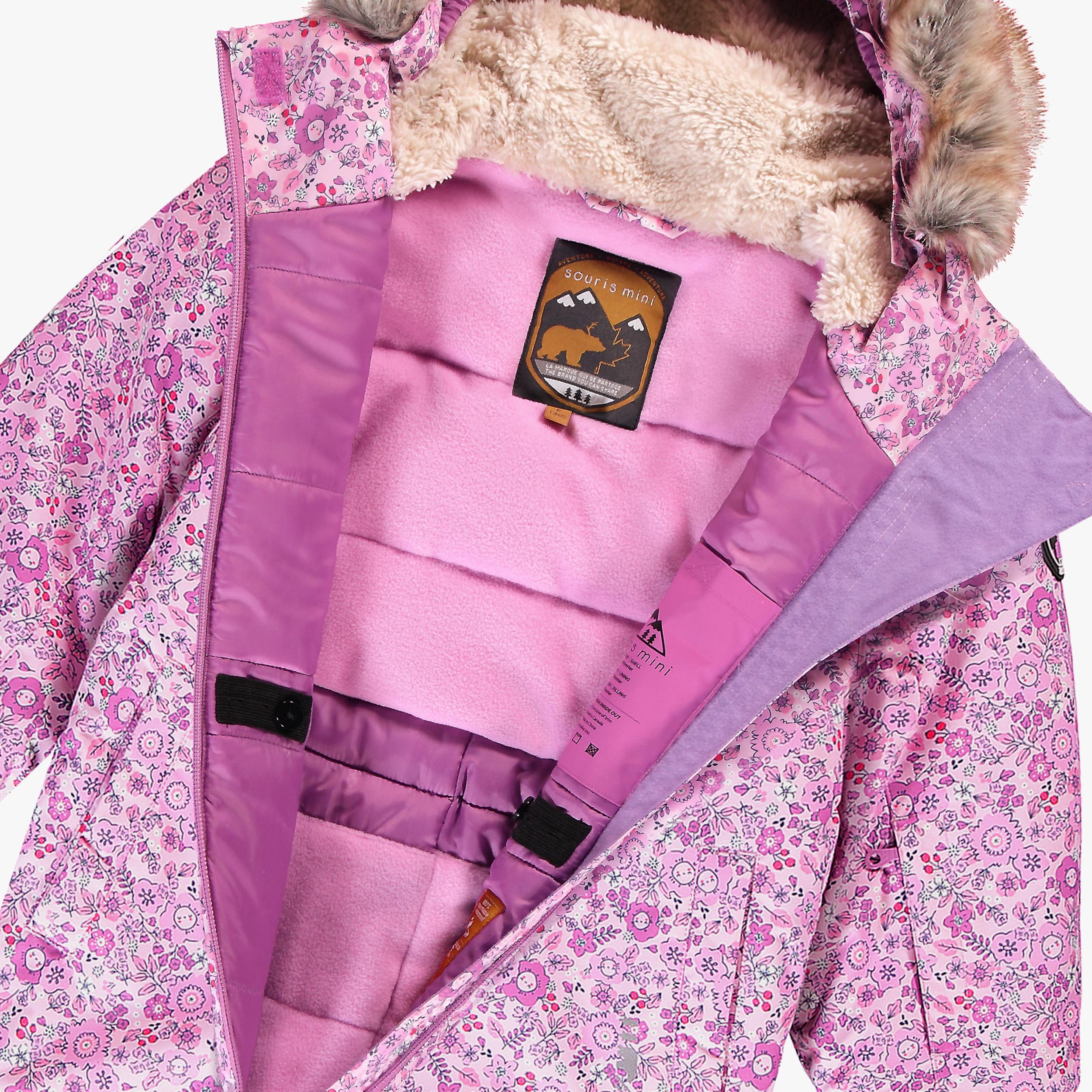 Intérieur de la combinaison de neige enfant rose avec doublure en polaire, capuche doublée et ceinture pare-neige intégrée.