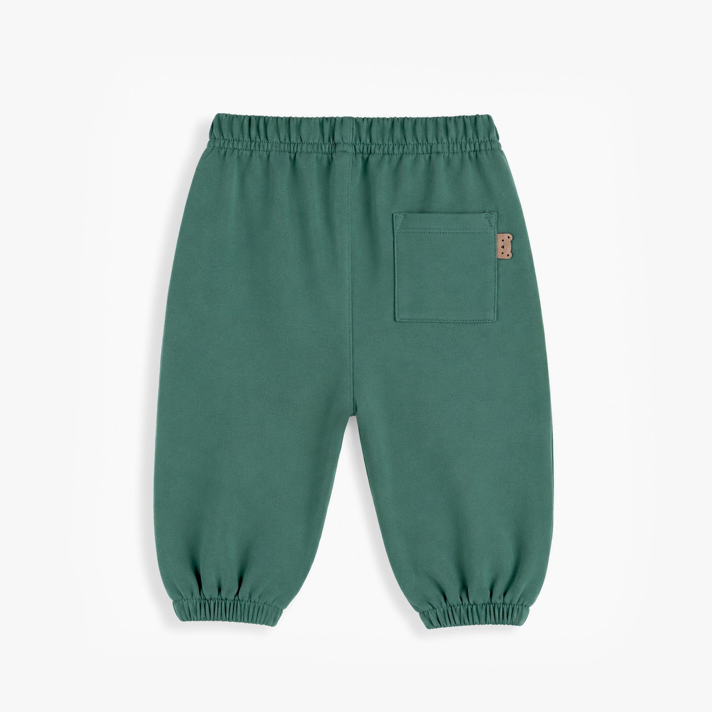 Dos du pantalon jogging bébé vert avec poche arrière et chevilles élastiquées