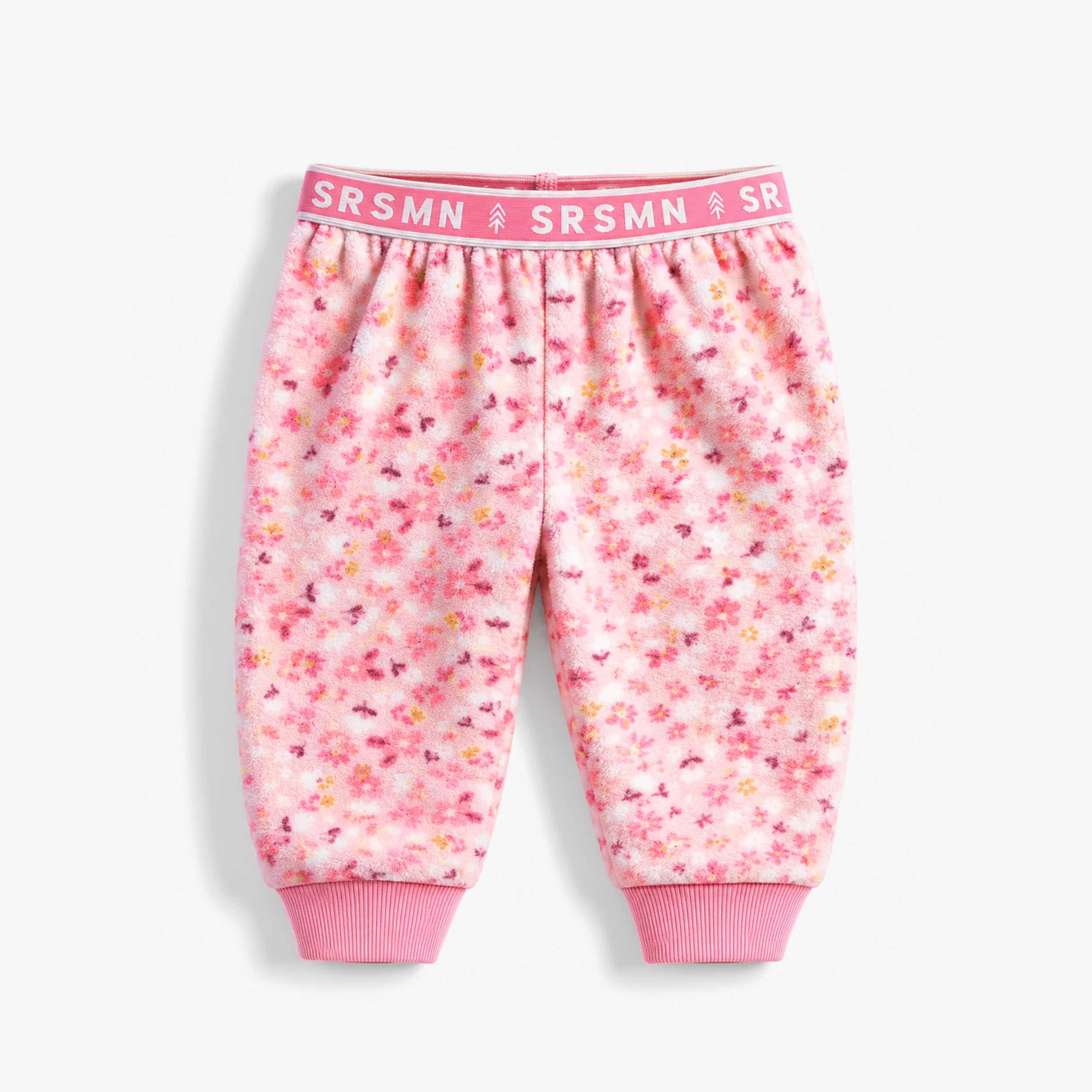 Pantalon rose en polar à imprimé floral pour bébé avec taille élastique et chevilles en tricot côtelé.