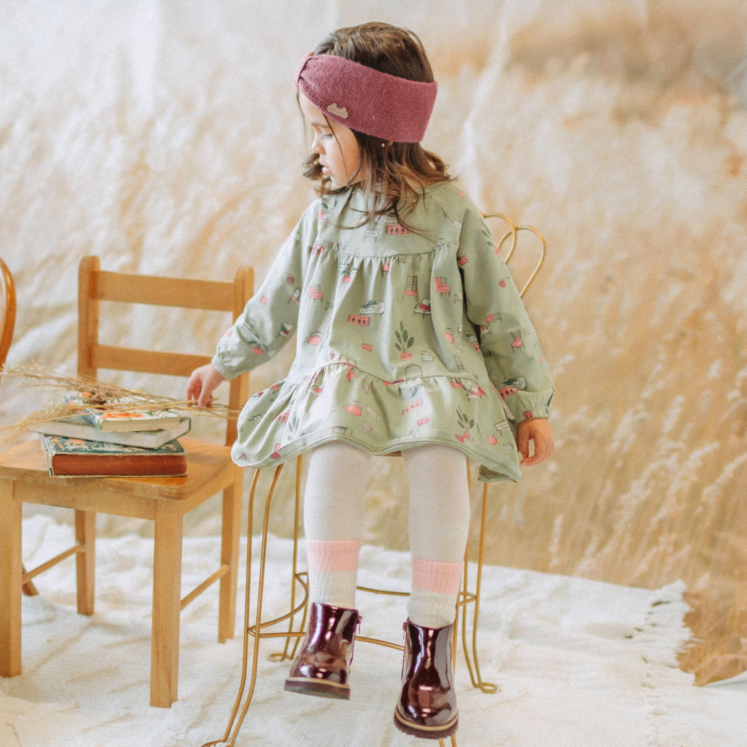 Sage green dress with illustrations of antique furniture in jersey, baby