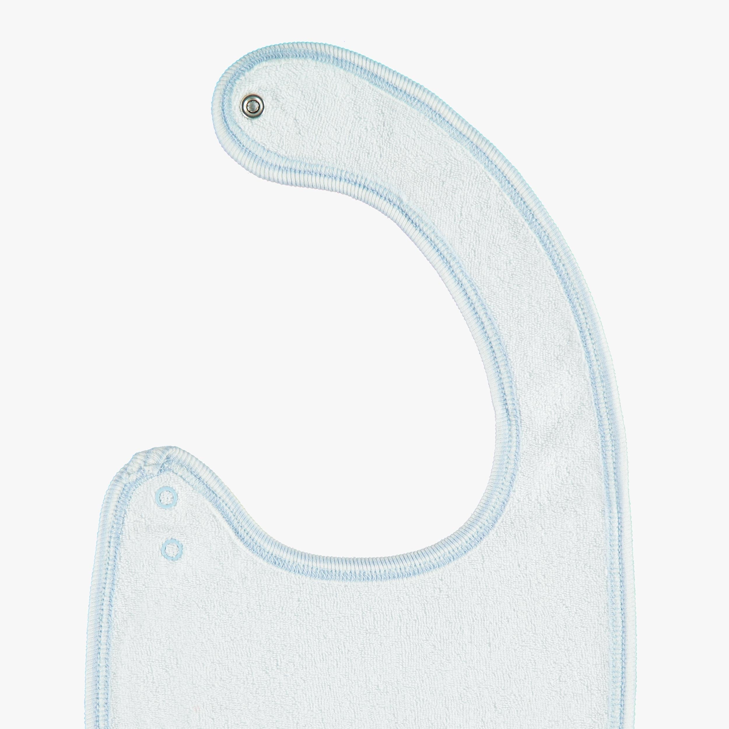 Revers du bavoir bleu à motifs de chiens, naissance