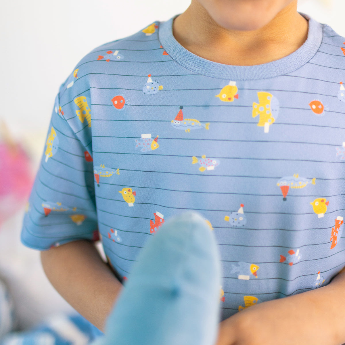 Blue two-piece pajamas with stripes and fish patterns, child
