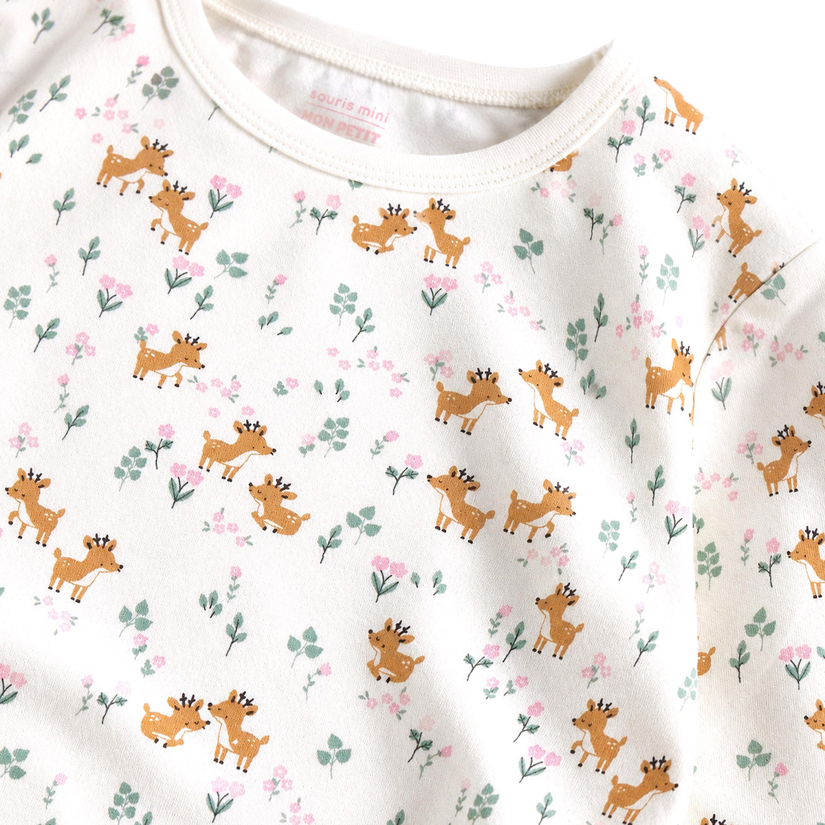 Two-piece cream pajama set with fawn and foliage print, child