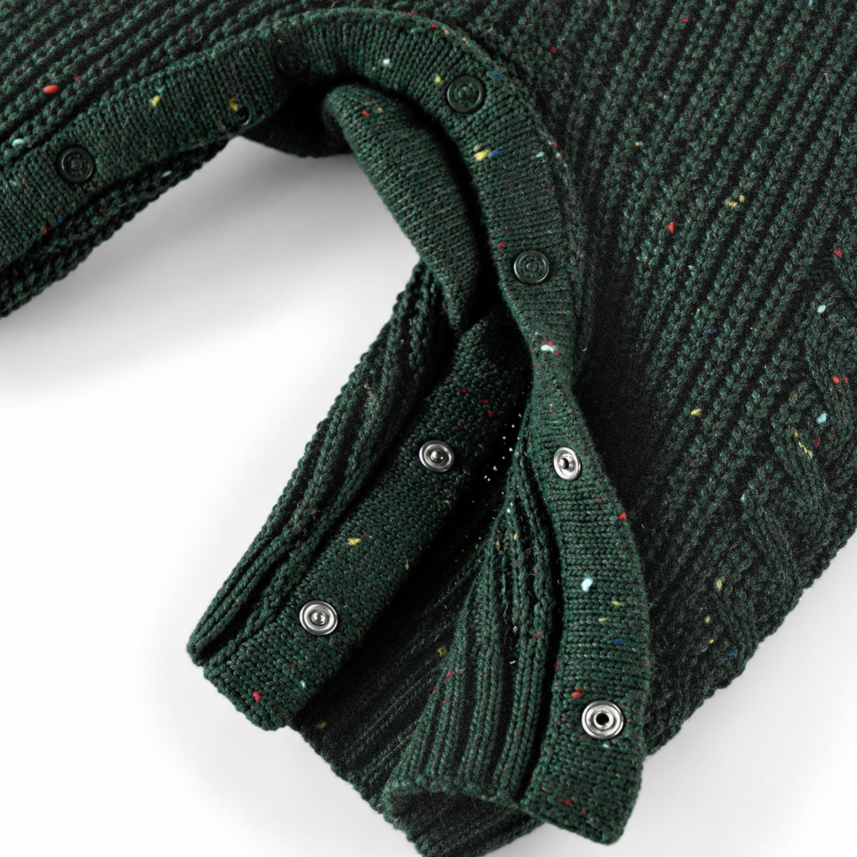 Salopette vert forêt en tricot moucheté, naissance