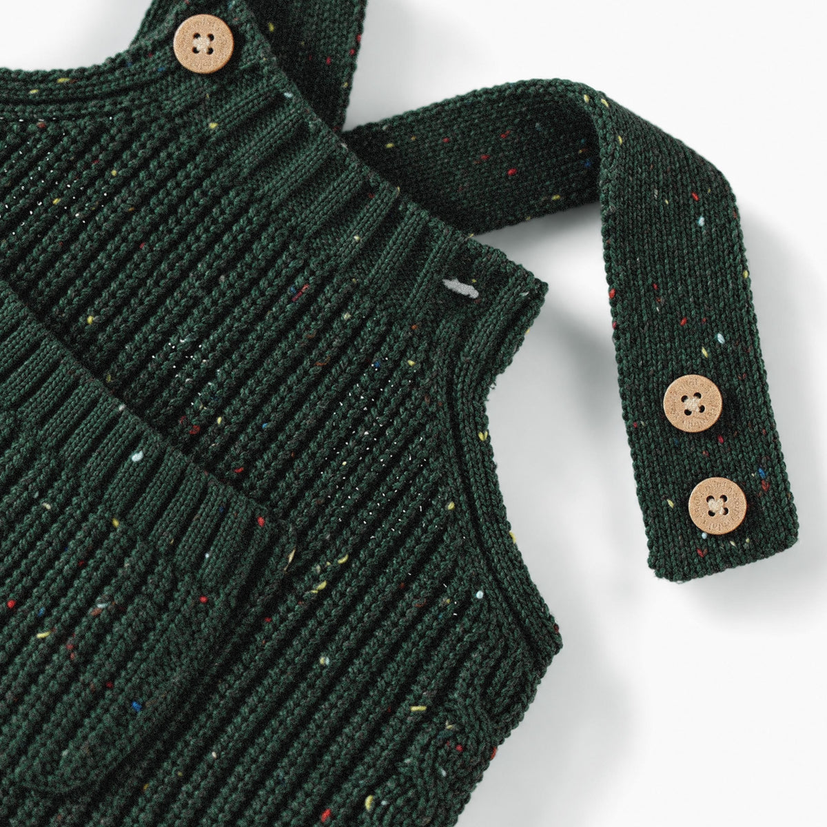 Salopette vert forêt en tricot moucheté, naissance
