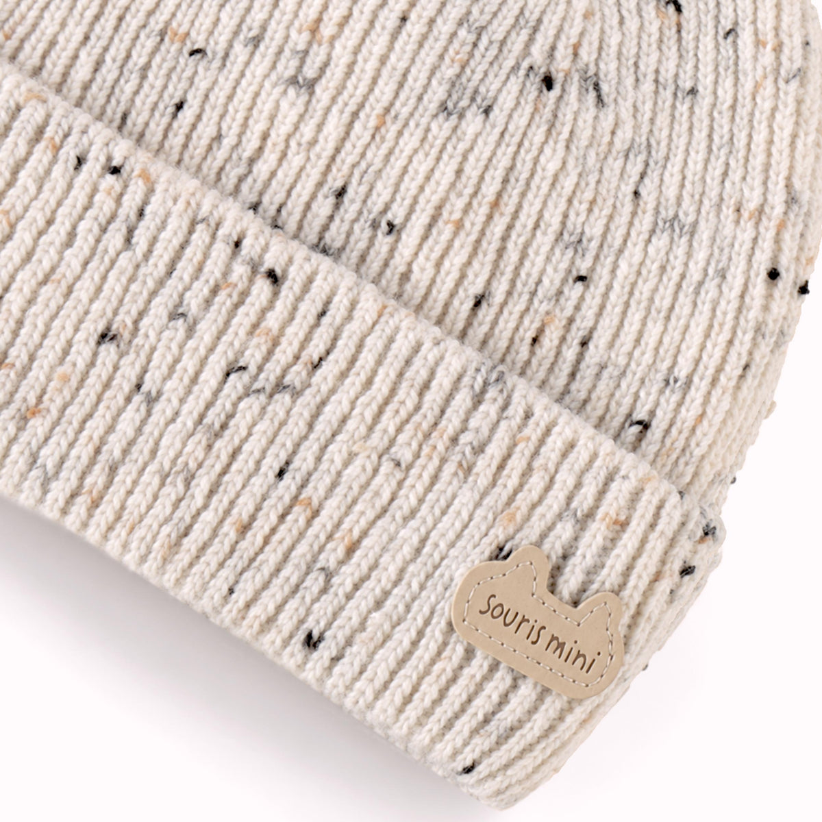 Tuque crème en tricot moucheté, naissance