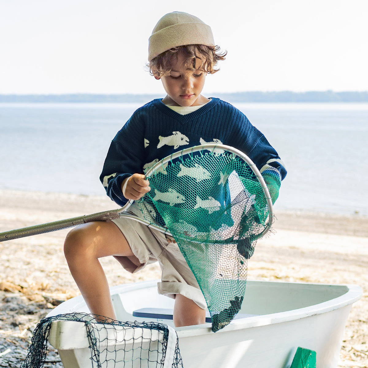 Blue knit sweater with fish, child