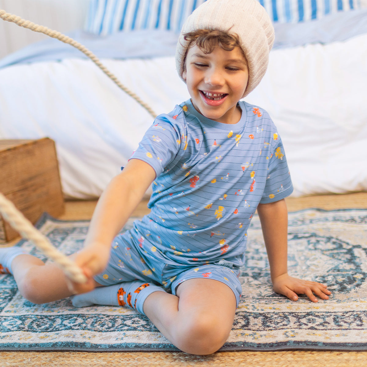 Blue two-piece pajamas with stripes and fish patterns, child