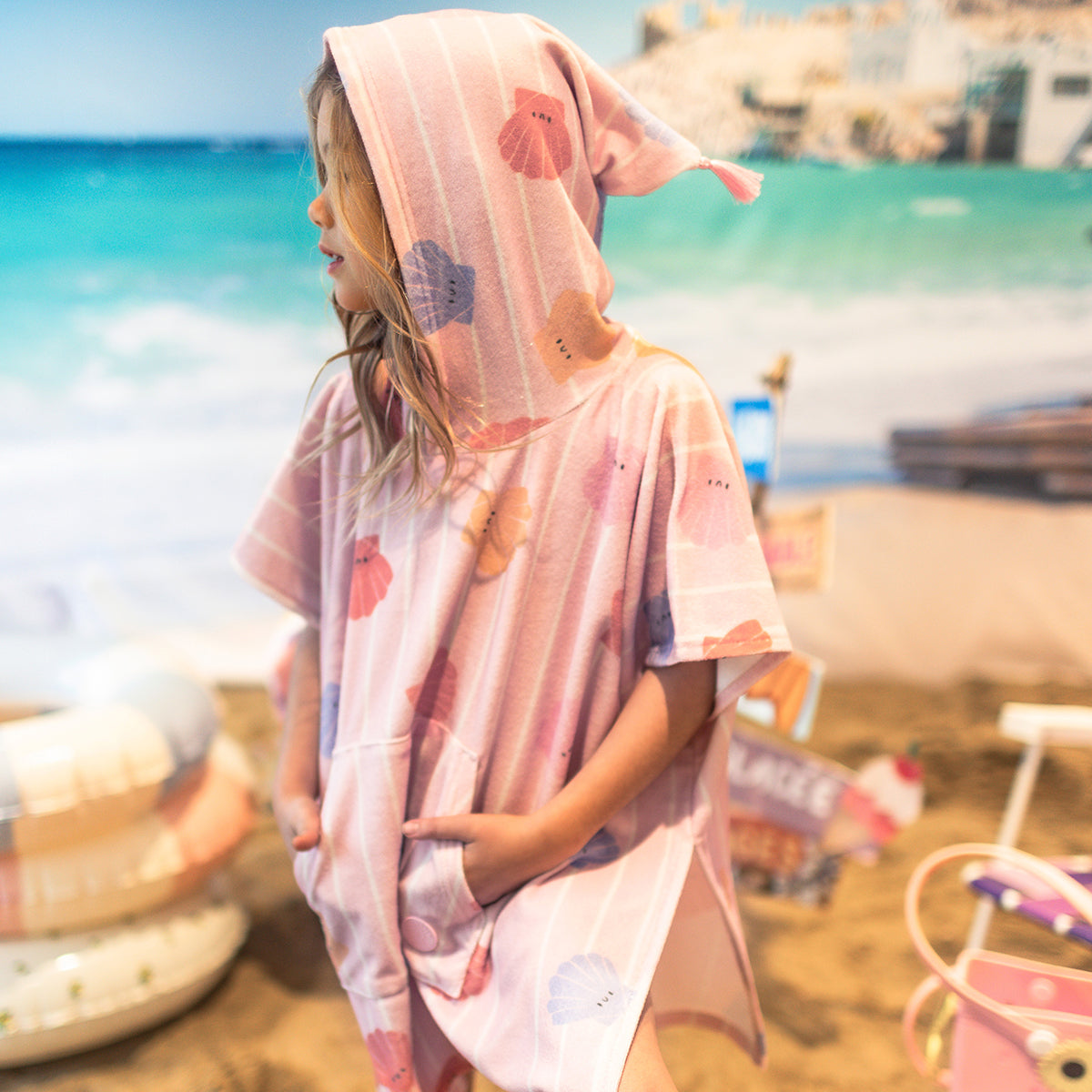 Pink beach poncho with stripes and seashells, child
