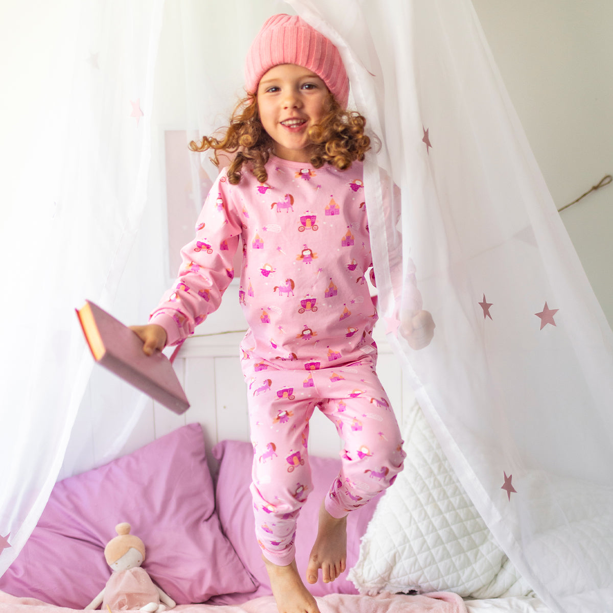 Pink two-piece pajamas with a fairy print, child