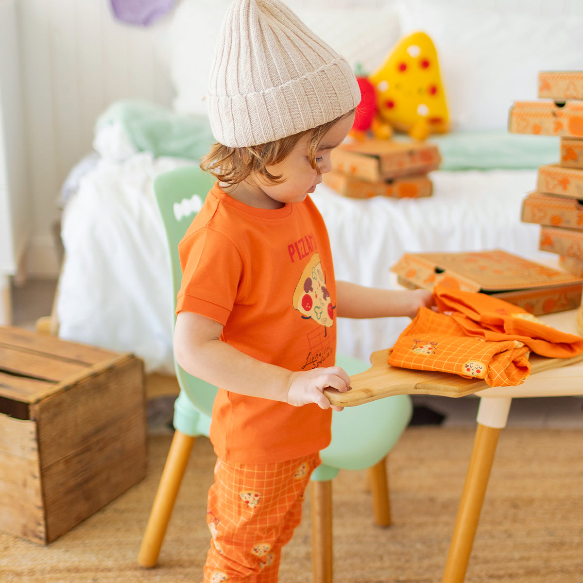Orange two-piece pajamas with pizza patterns, baby