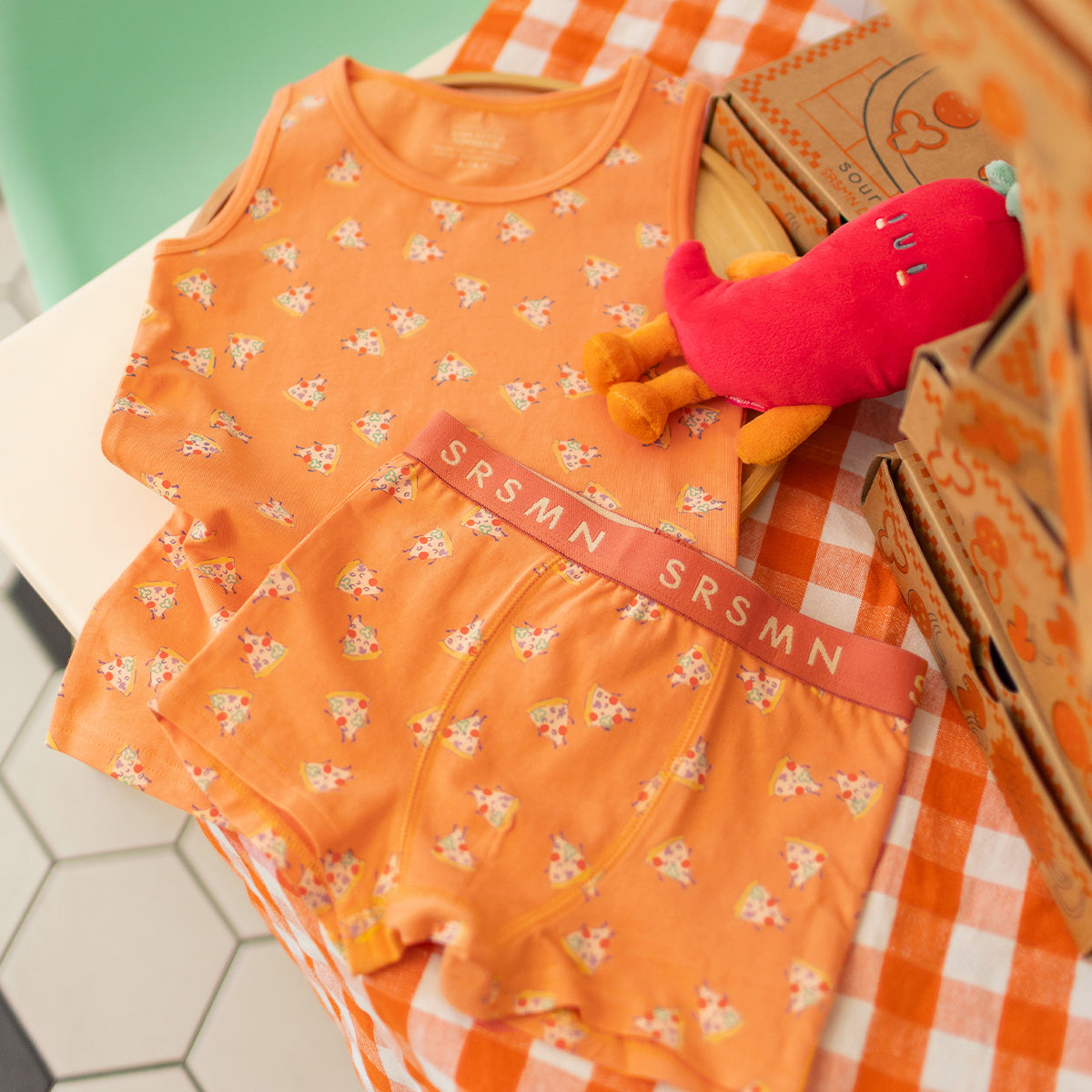 Orange camisole with pizza patterns, child