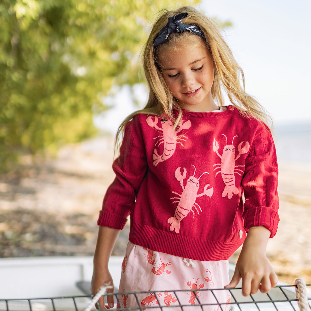 Red knit sweater with lobster print, child