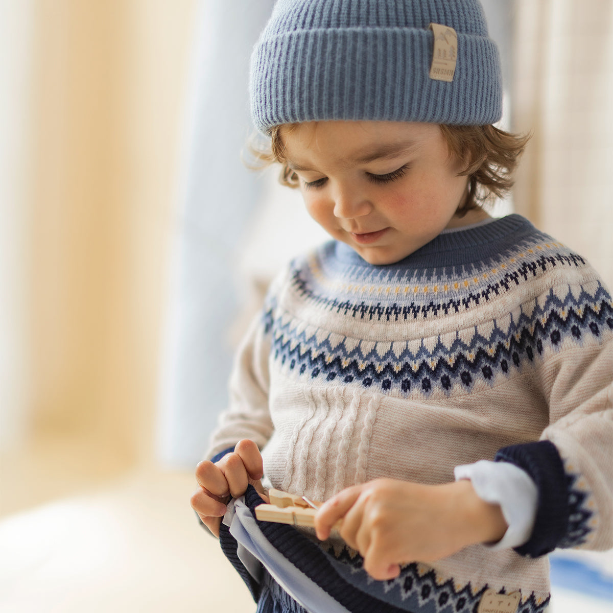 Cream-colored knitted sweater with jacquard pattern, baby