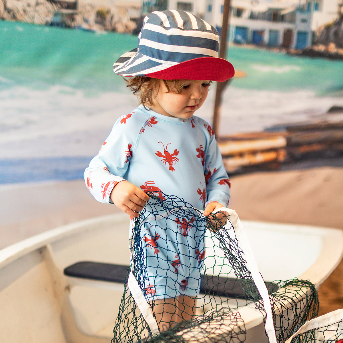 Light blue one-piece swimsuit with lobster patterns, baby