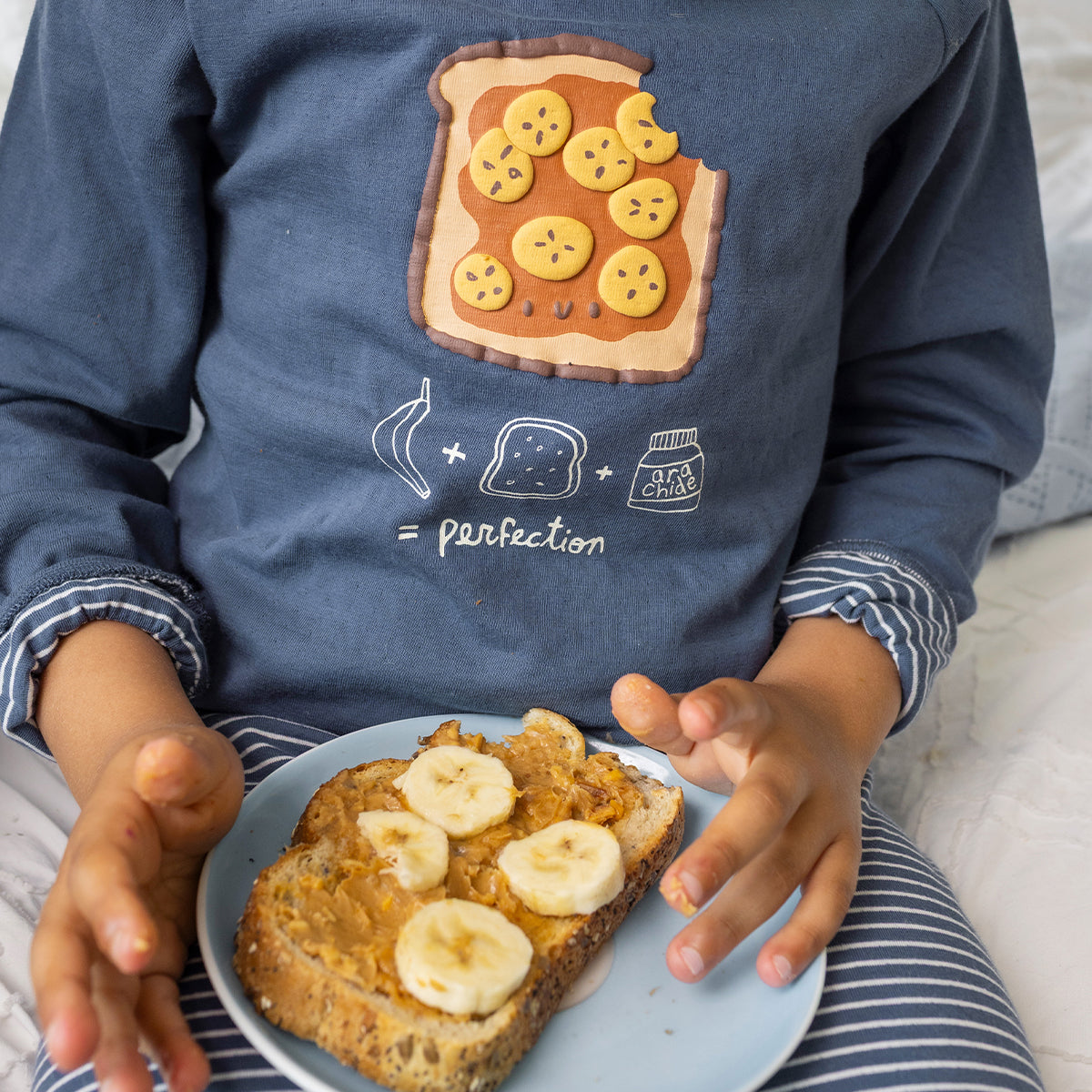 Blue two-piece pajamas with a toast illustration, child