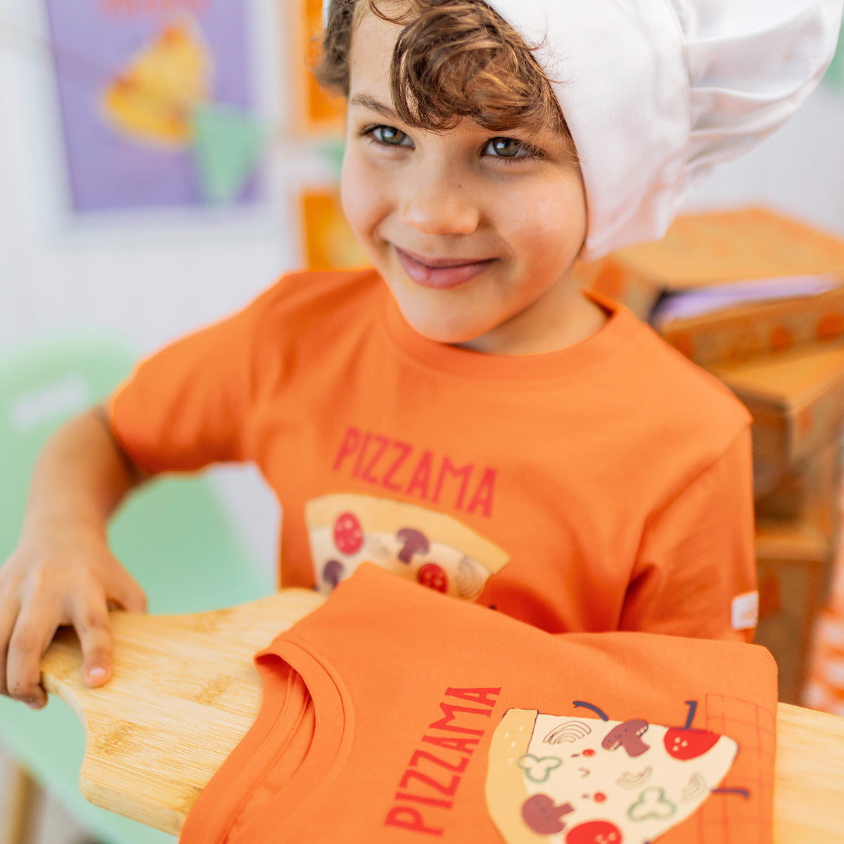 Orange two-piece pajamas with pizza patterns, child