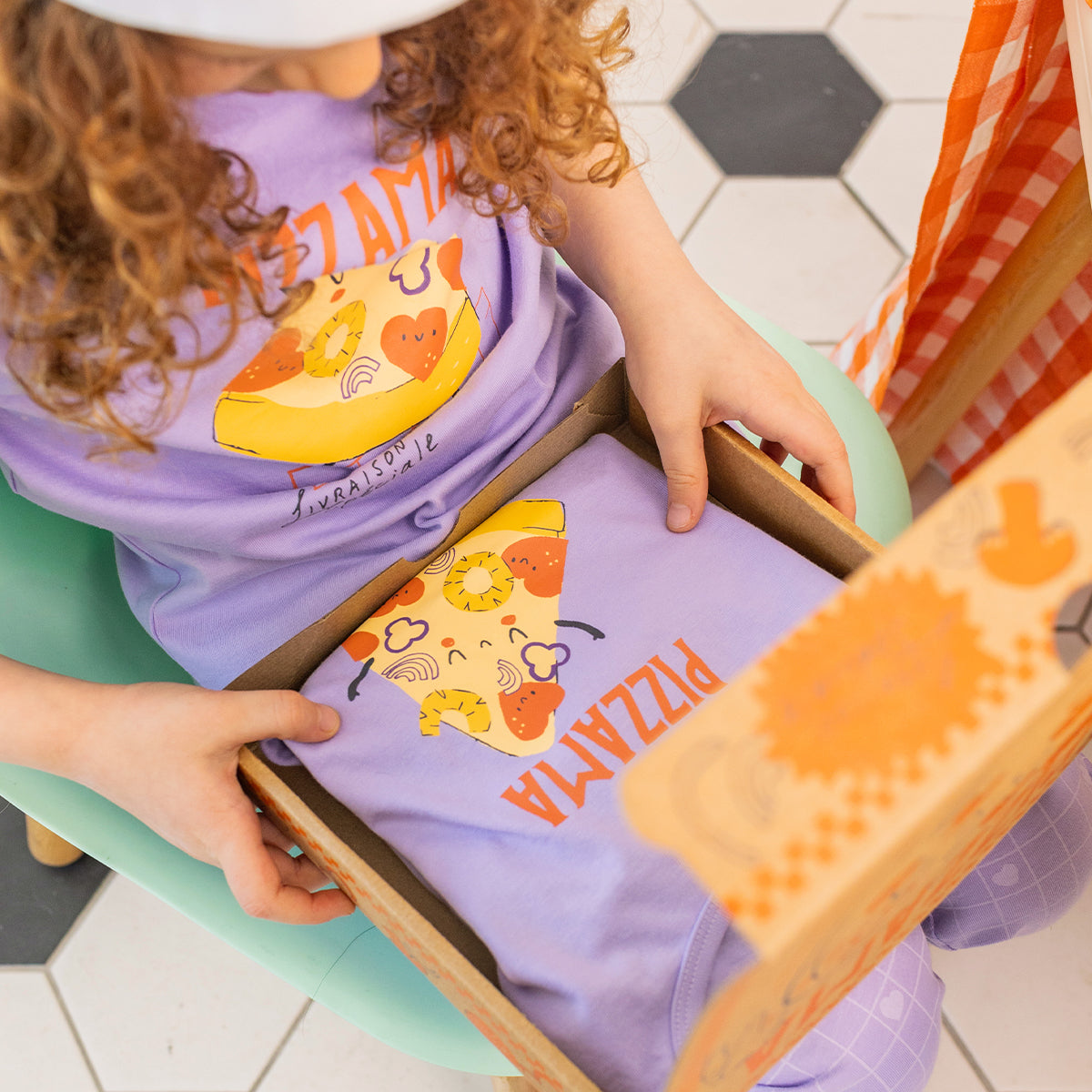 Two-piece purple pajamas with pizza patterns, child