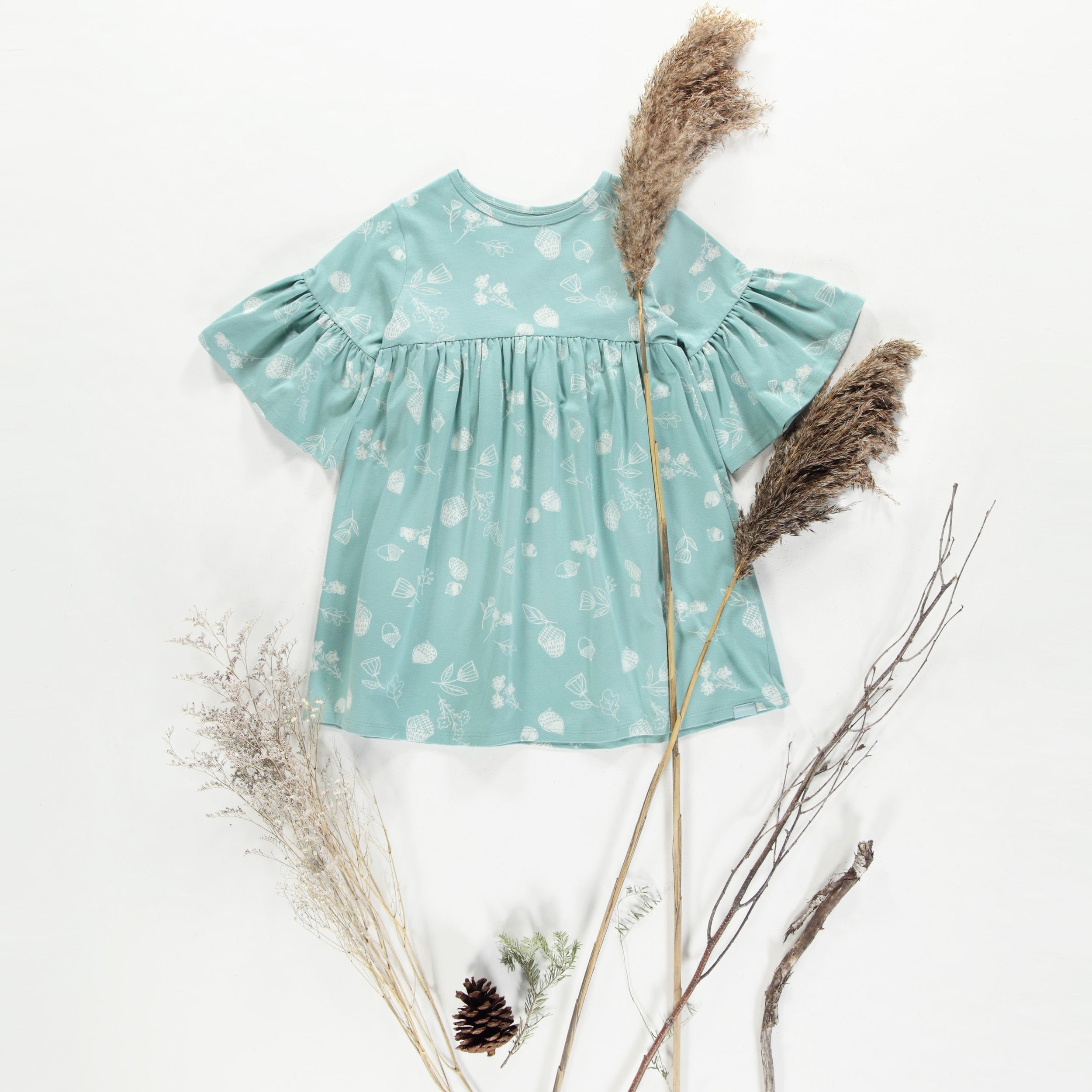 Light turquoise dress with hazelnuts pattern in soft jersey, child