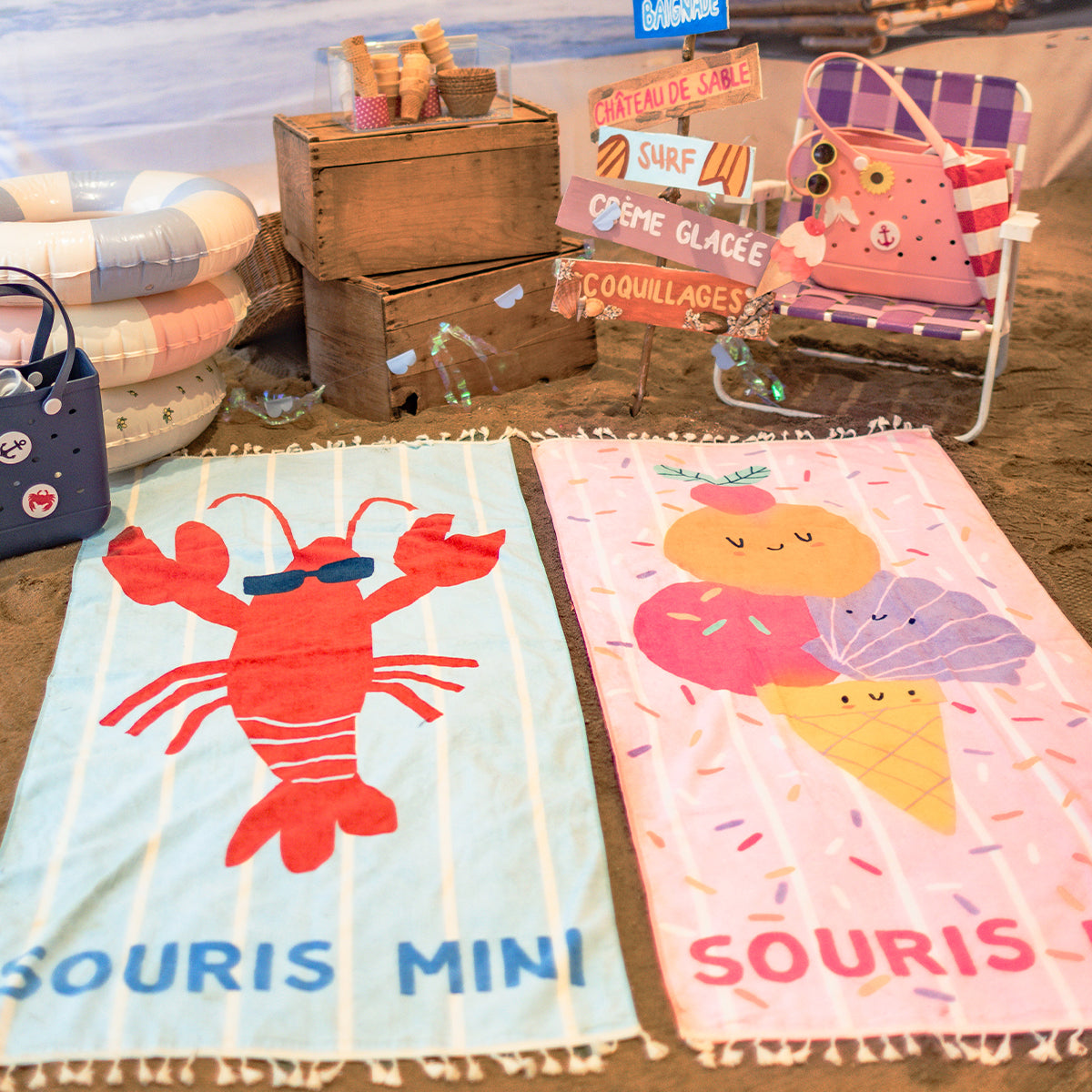 Pink beach towel with stripes, confetti, and ice cream, child