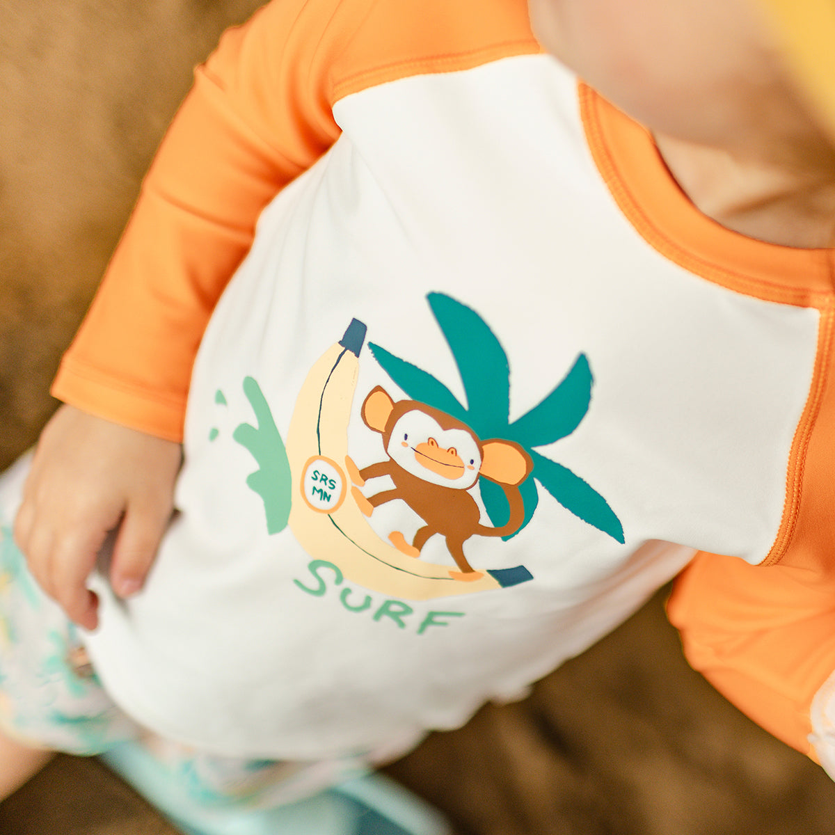 Cream and orange rashguard with illustration, baby