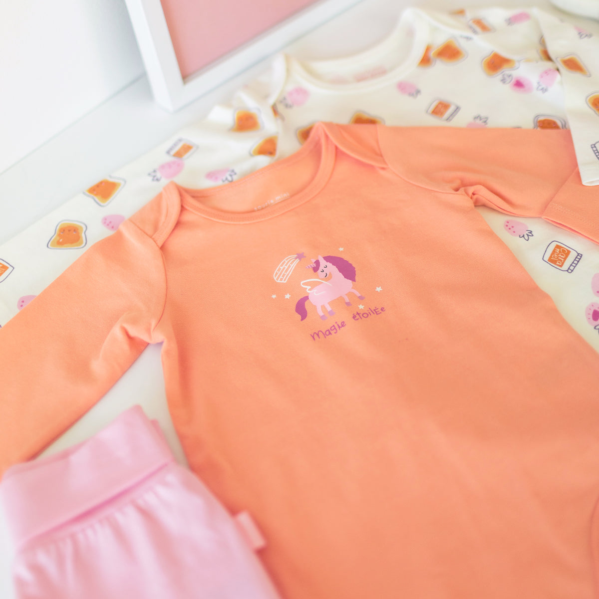 Coral bodysuit with unicorn illustration, baby