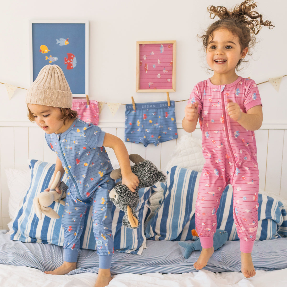Pink one-piece pajamas with stripes and fish patterns, baby