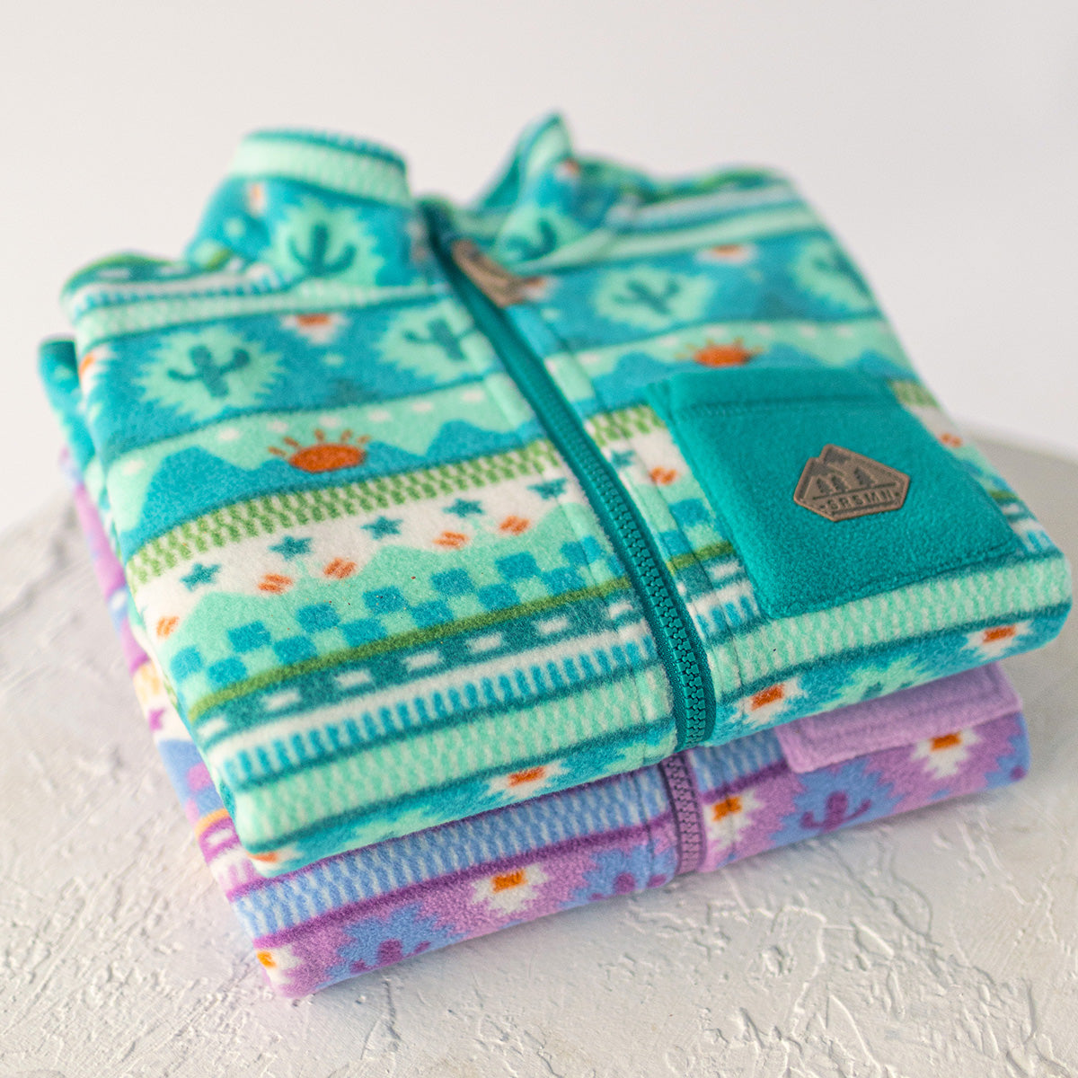 Veste en polar turquoise à motifs, enfant