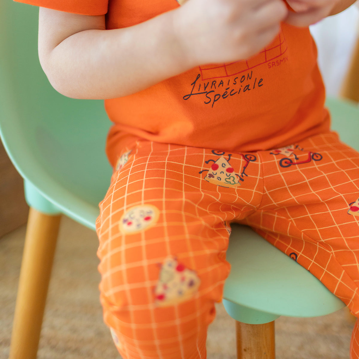 Orange two-piece pajamas with pizza patterns, baby