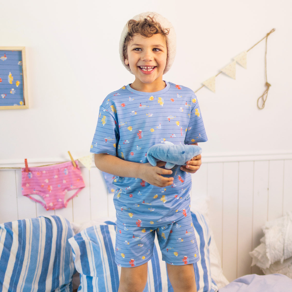 Blue two-piece pajamas with stripes and fish patterns, child
