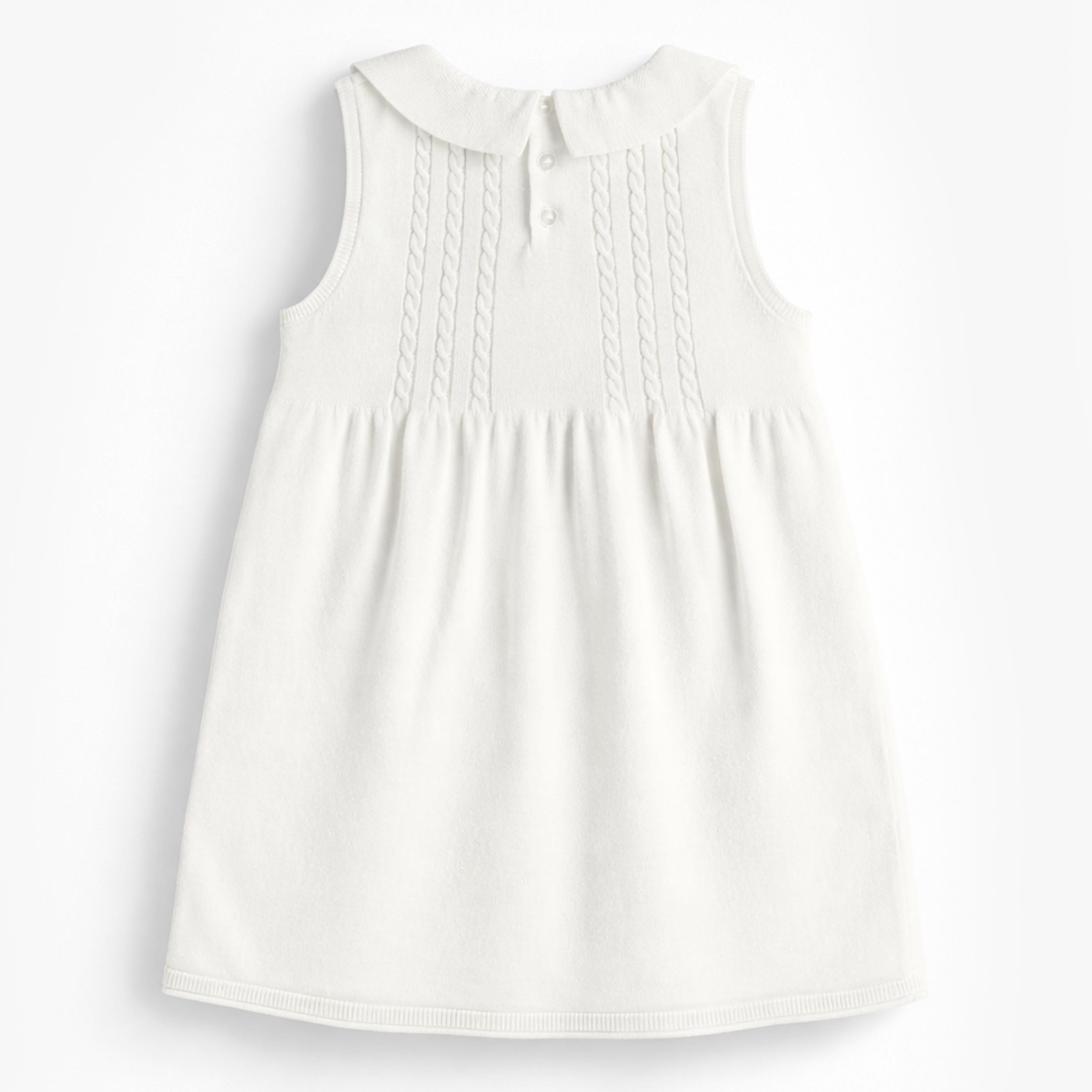 Dos de la robe blanche en tricot avec broderies de fleurs, enfant