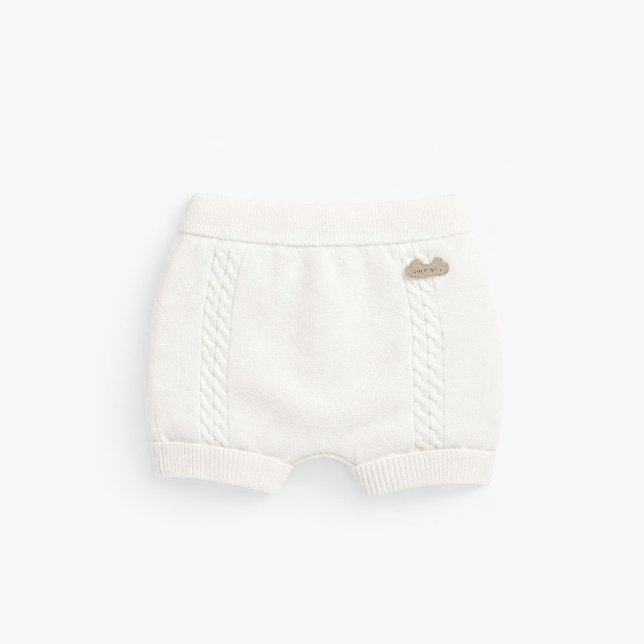 Dos du short crème en tricot, naissance