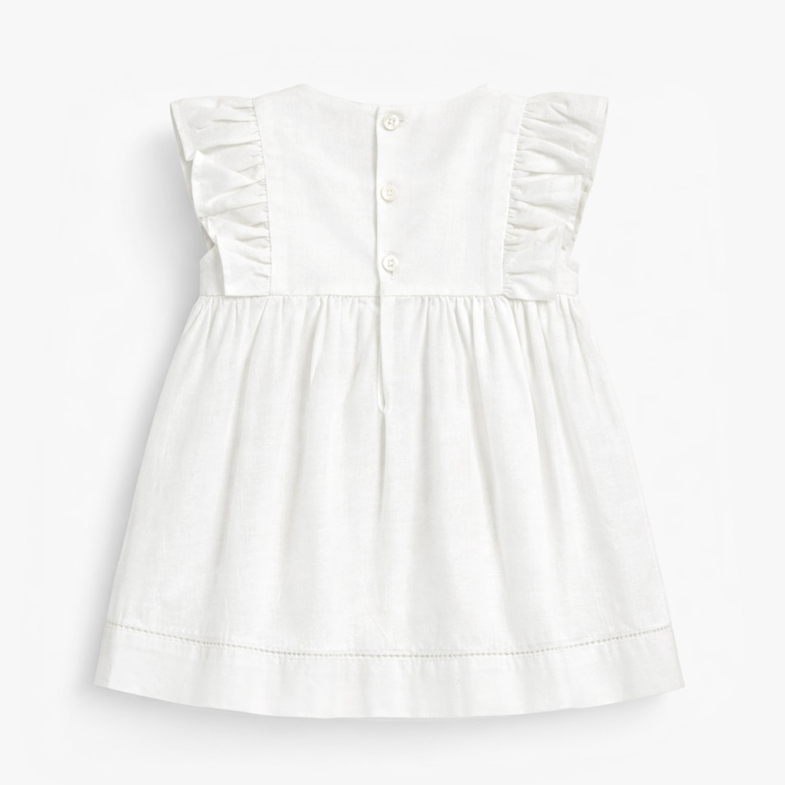 Dos de la robe blanche en coton et lin, bébé