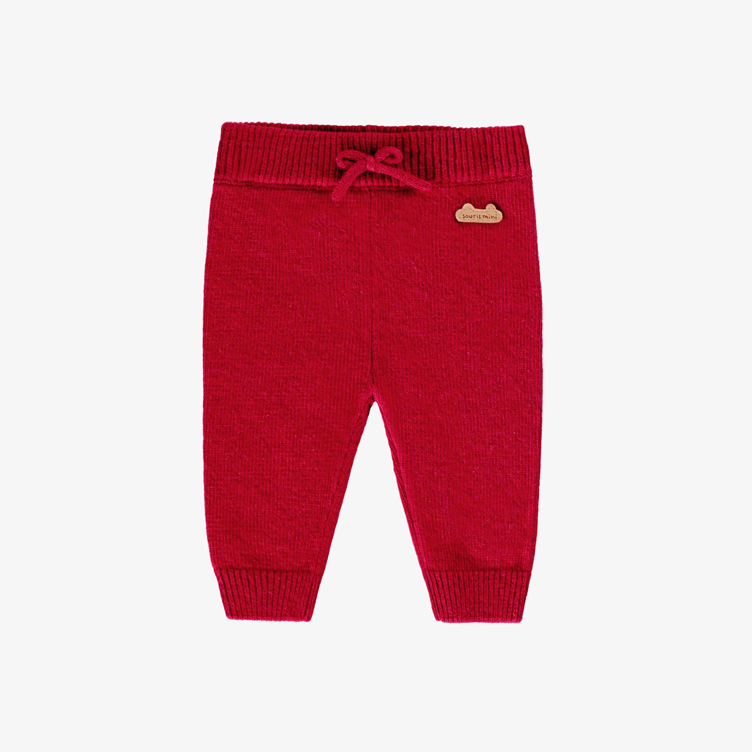 Pantalon rouge en tricot, naissance