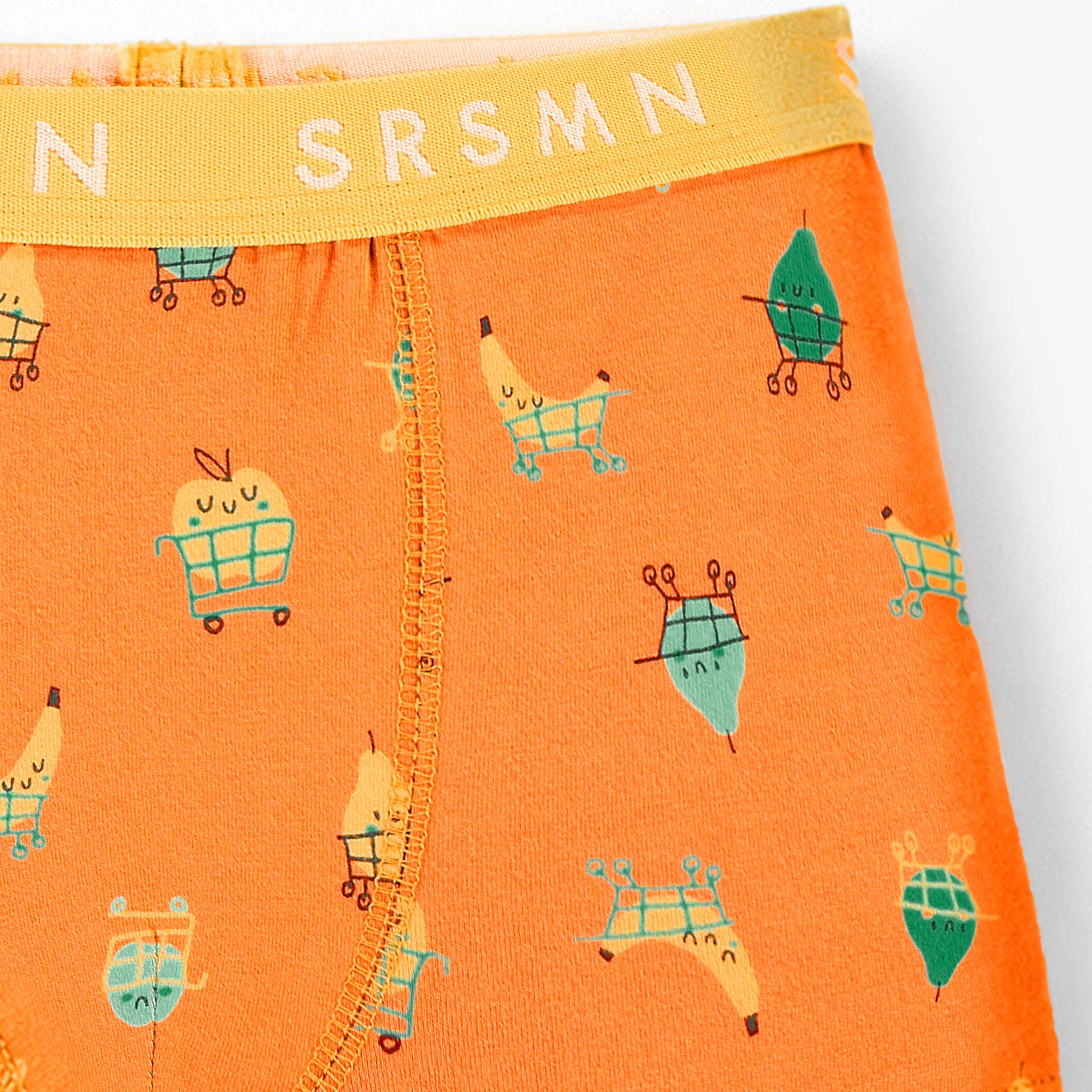 Zoom détails du boxer orange à motifs fruités, enfant