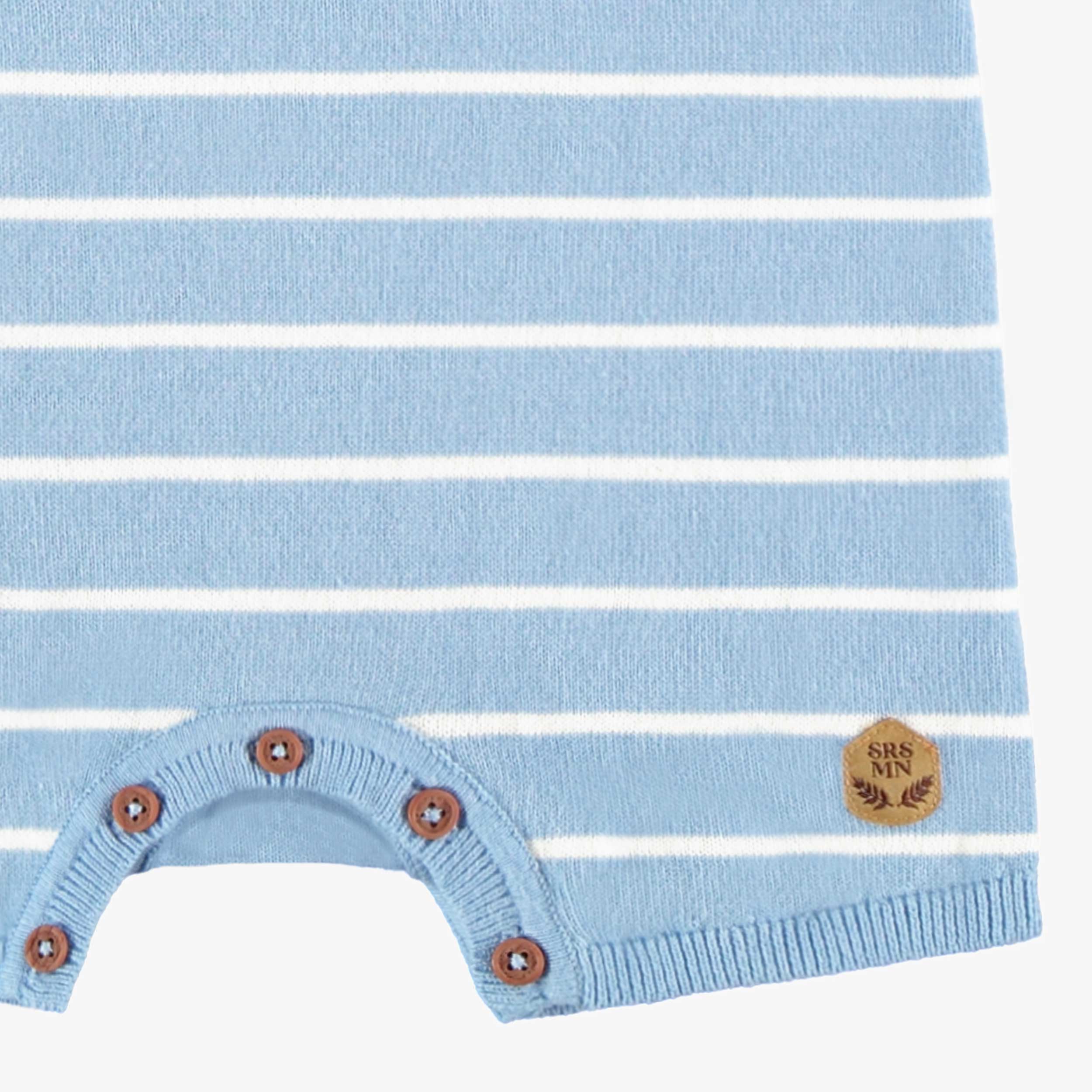 Zoom détails bas de la barboteuse bleue en tricot avec rayures blanches, bébé 