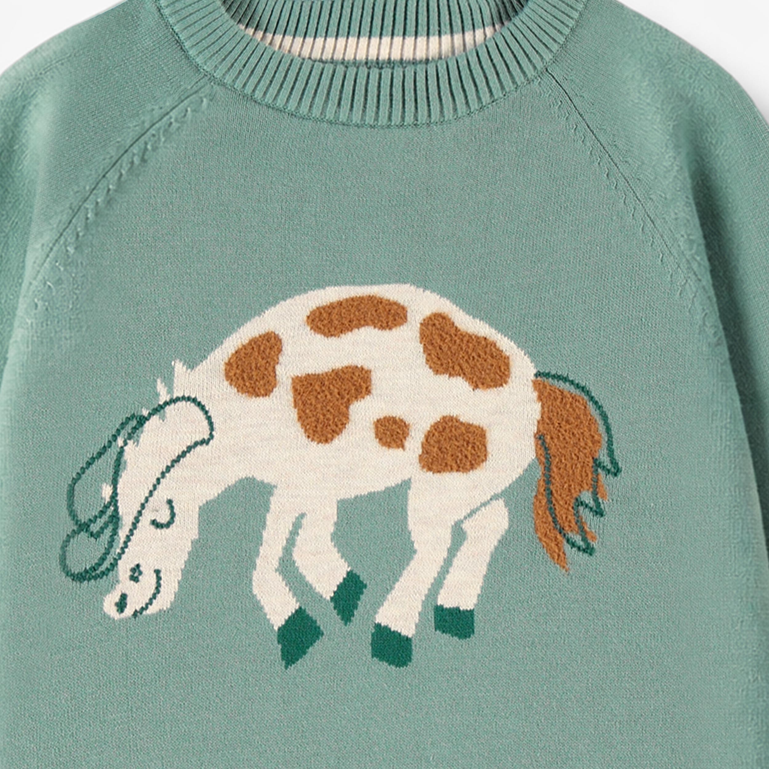 Zoom détails du chandail turquoise en tricot à motif de cheval, enfant