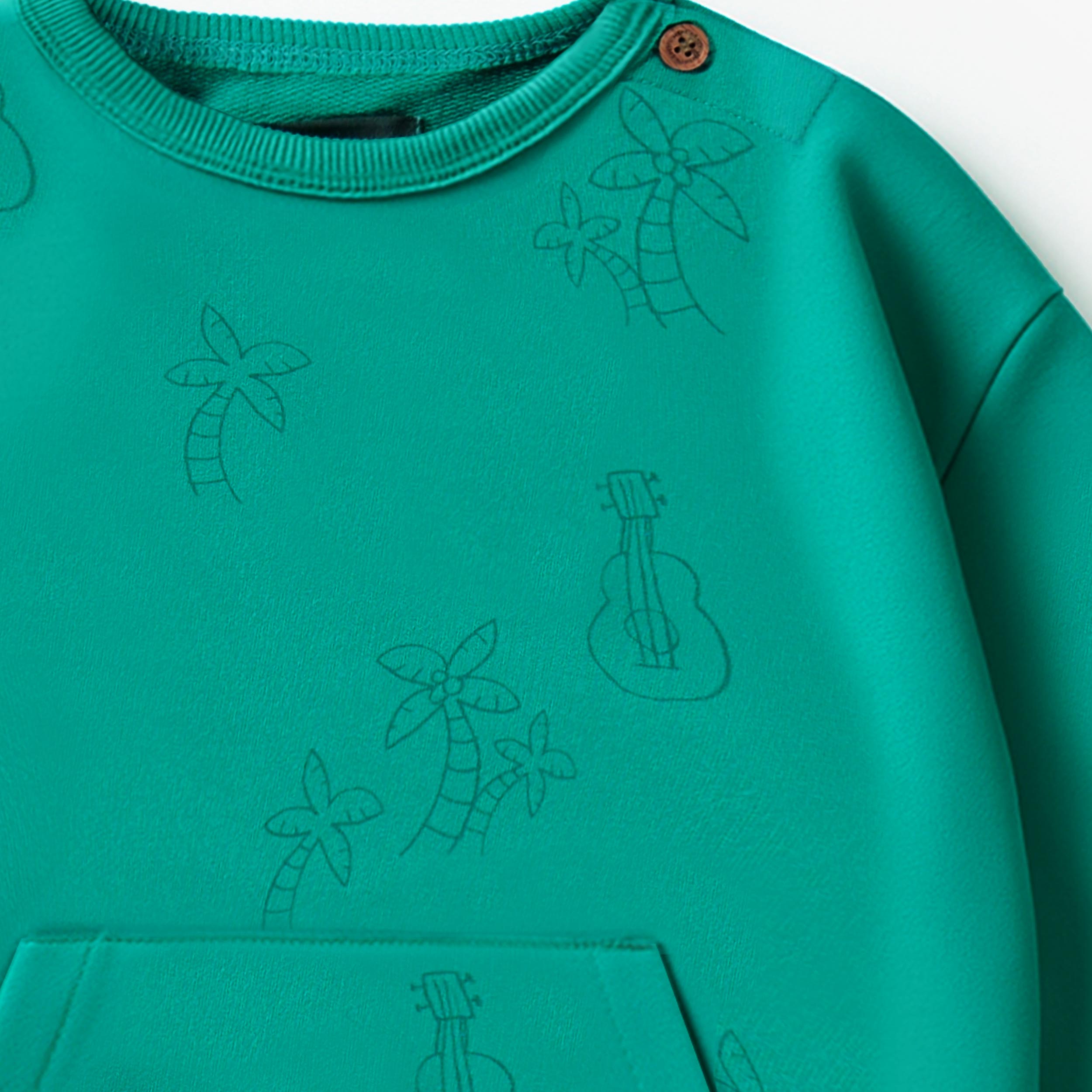 Zoom haut du chandail turquoise à motifs de palmiers et guitares, bébé - Souris Mini