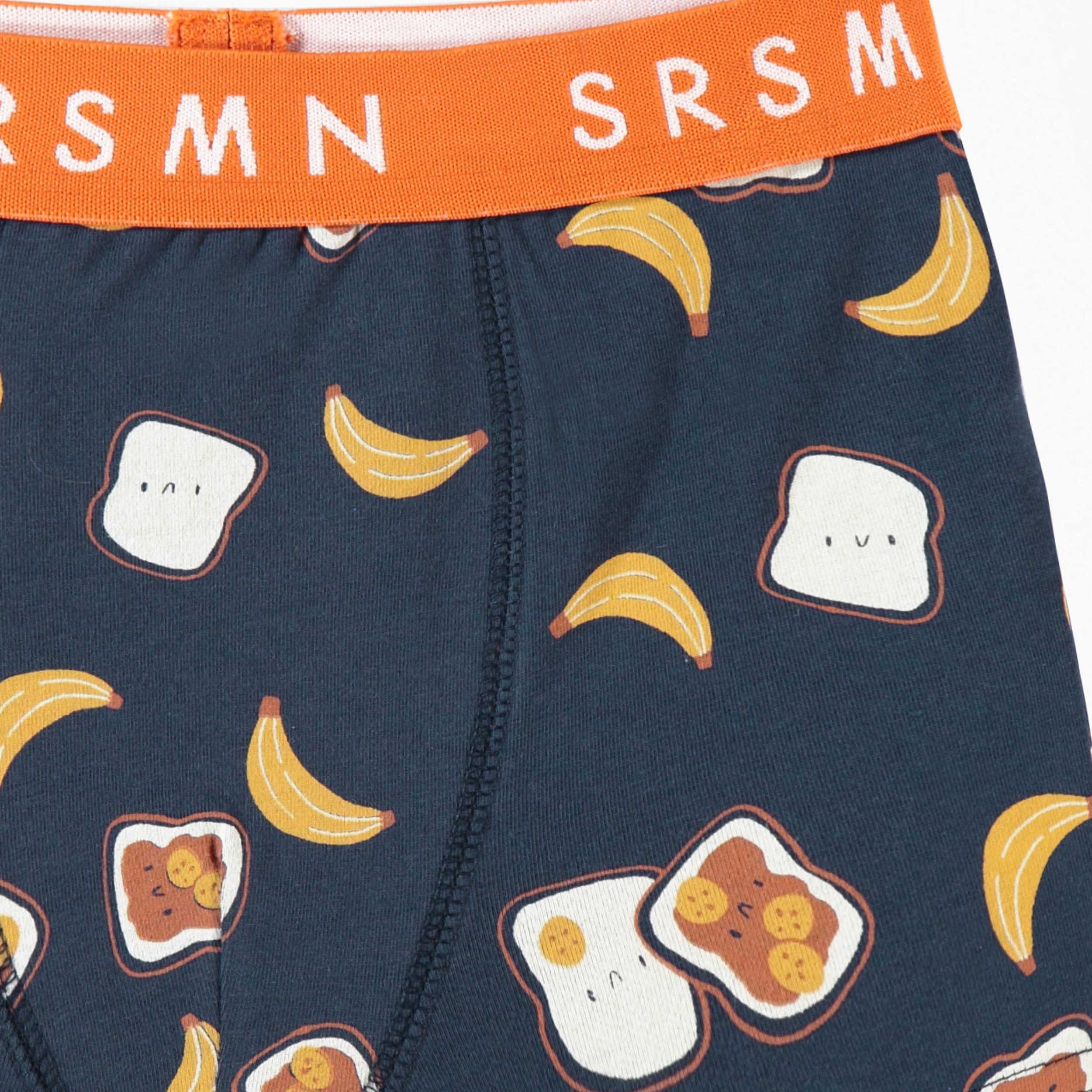 Zoom détails du Boxer ajusté bleu foncé à imprimé de tartines et bananes, enfant 