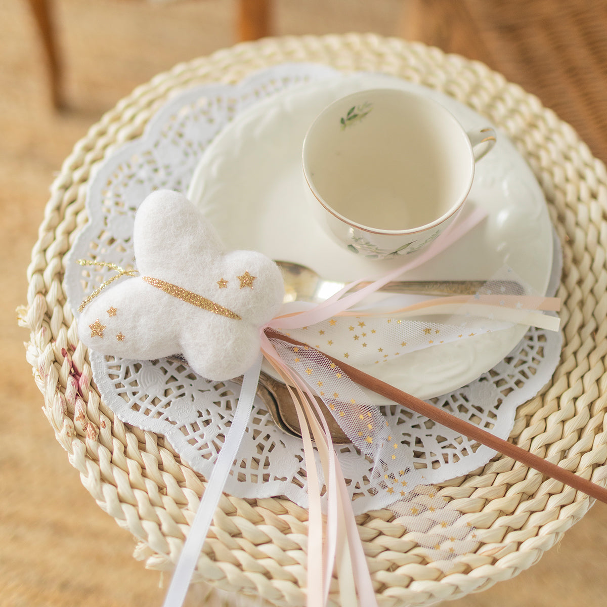 Baguette magique de fée blanche avec étoile dorée et rubans roses et dorés, accessoire de déguisement féerique pour enfant.