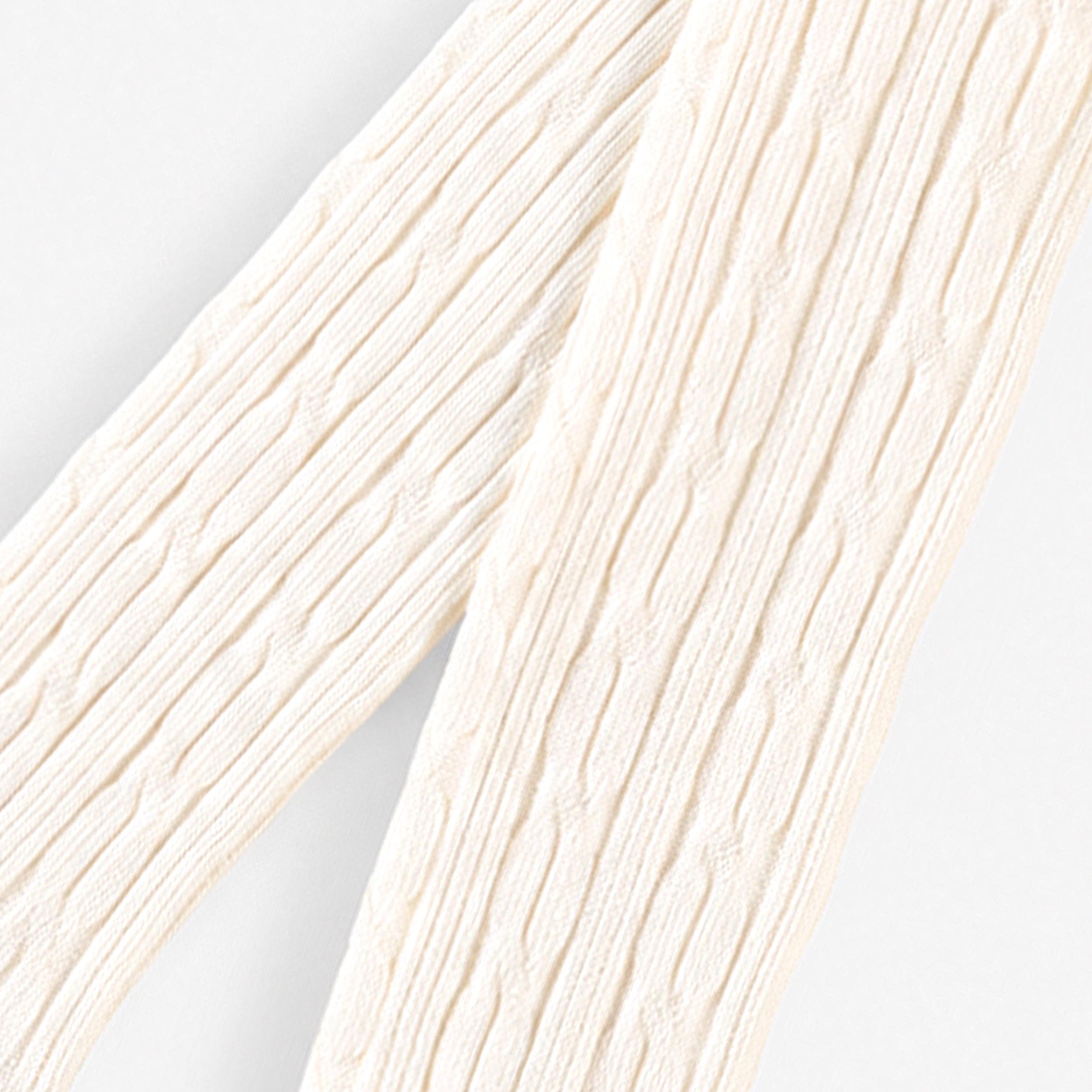 Détail de la maille torsadée des collants bébé écrus en coton doux