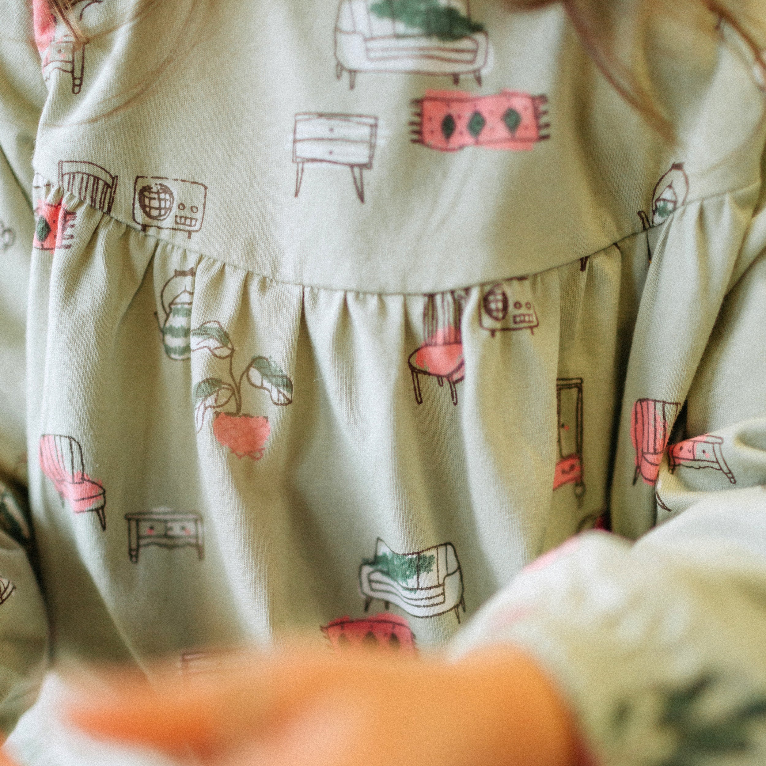 Sage green dress with illustrations of antique furniture in jersey, baby