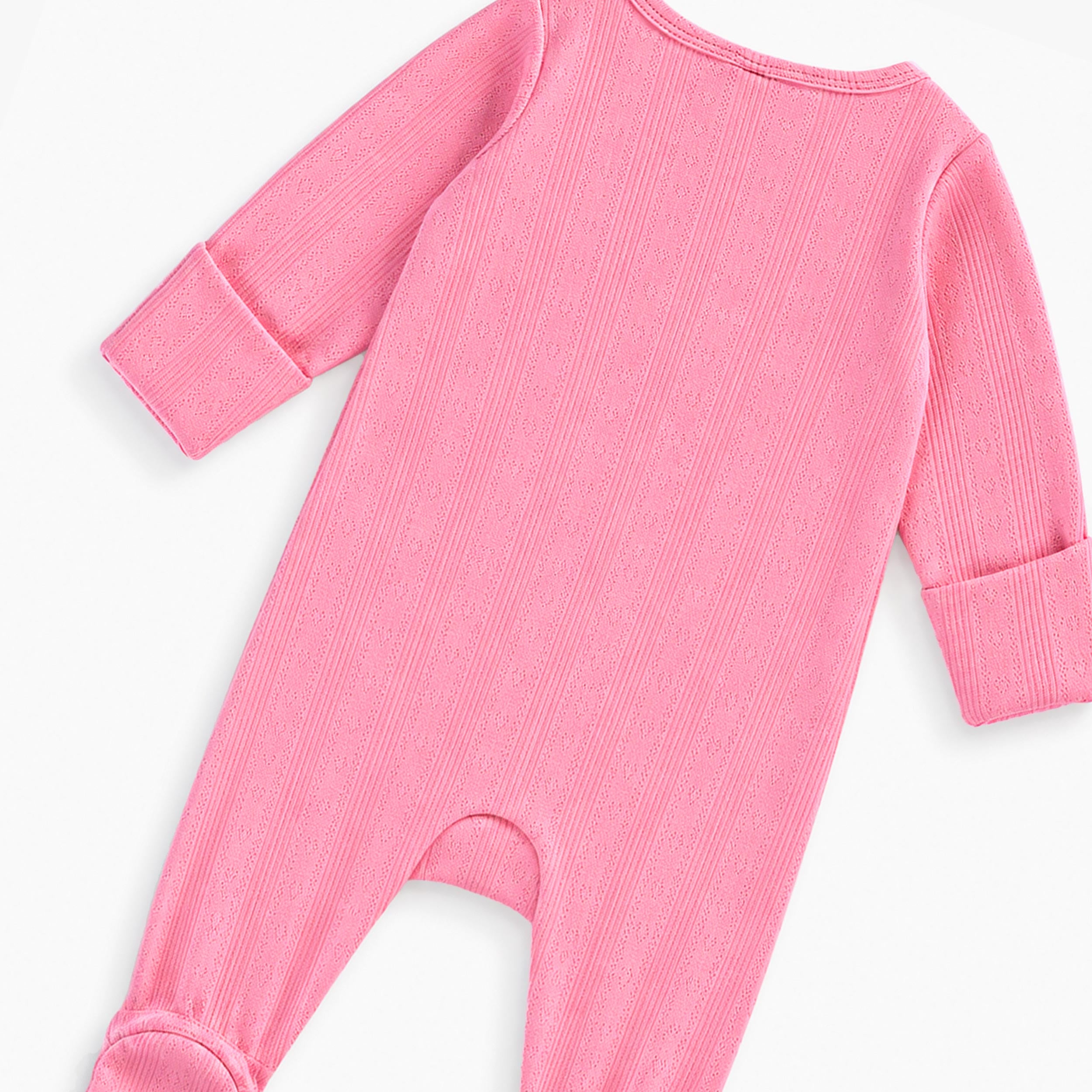 Vue arrière d’un pyjama bébé fille rose en maille texturée à manches longues avec pieds intégrés.